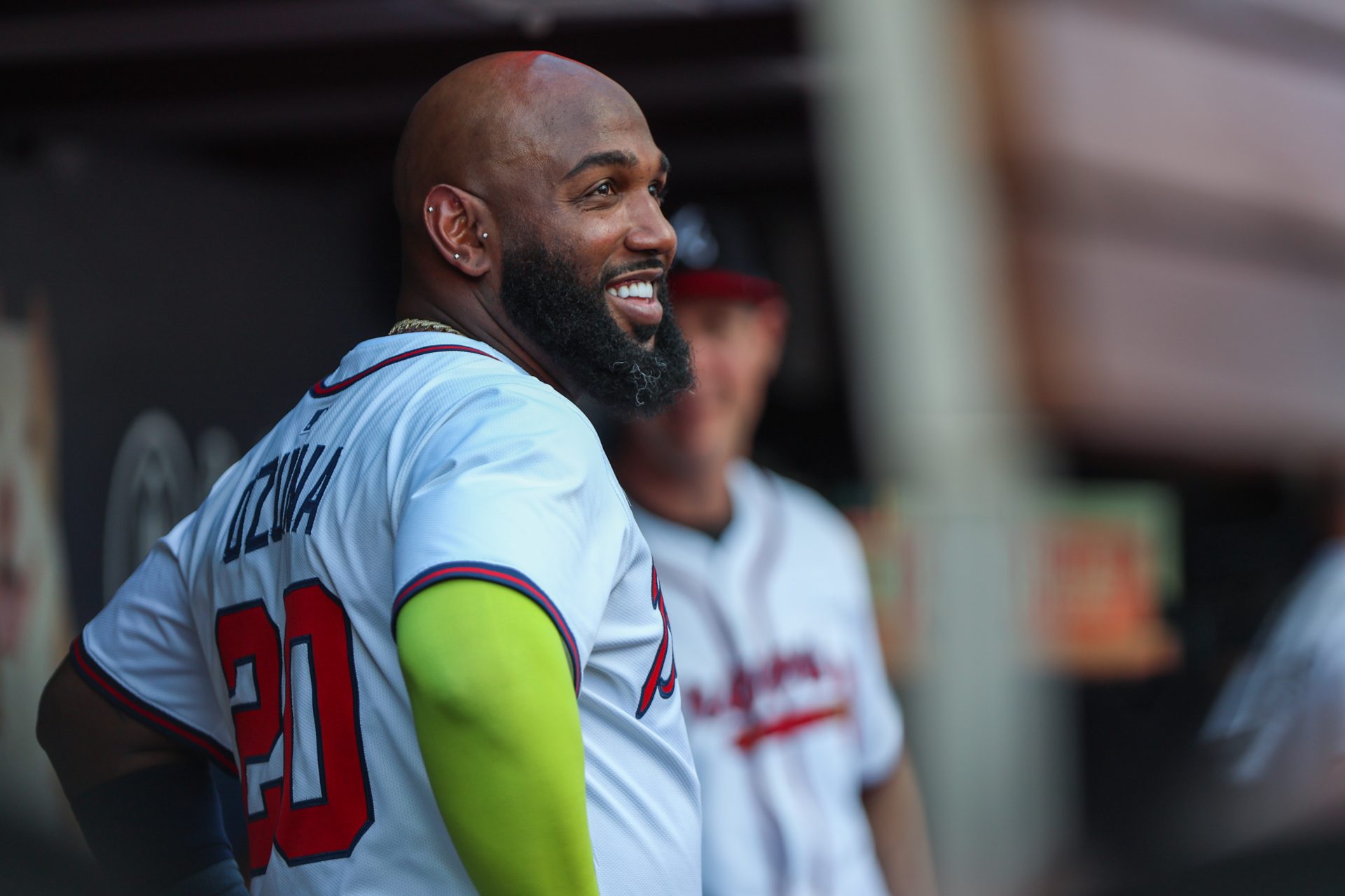Atlanta Braves designated hitter Marcell Ozuna (20) smiles in the dugout during the game against the Pittsburgh Pirates during the third inning at Truist Park.