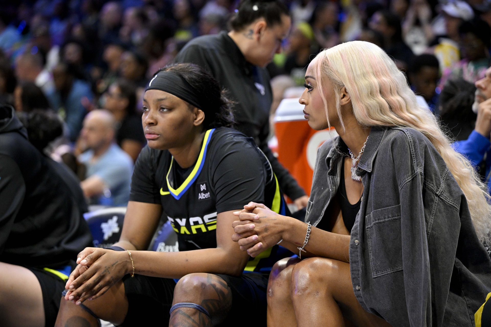 Dallas Wings forward NaLyssa Smith (1) and guard DiJonai Carrington (21) look on from the team bench during the first half against the Washington Mystics at College Park Center.