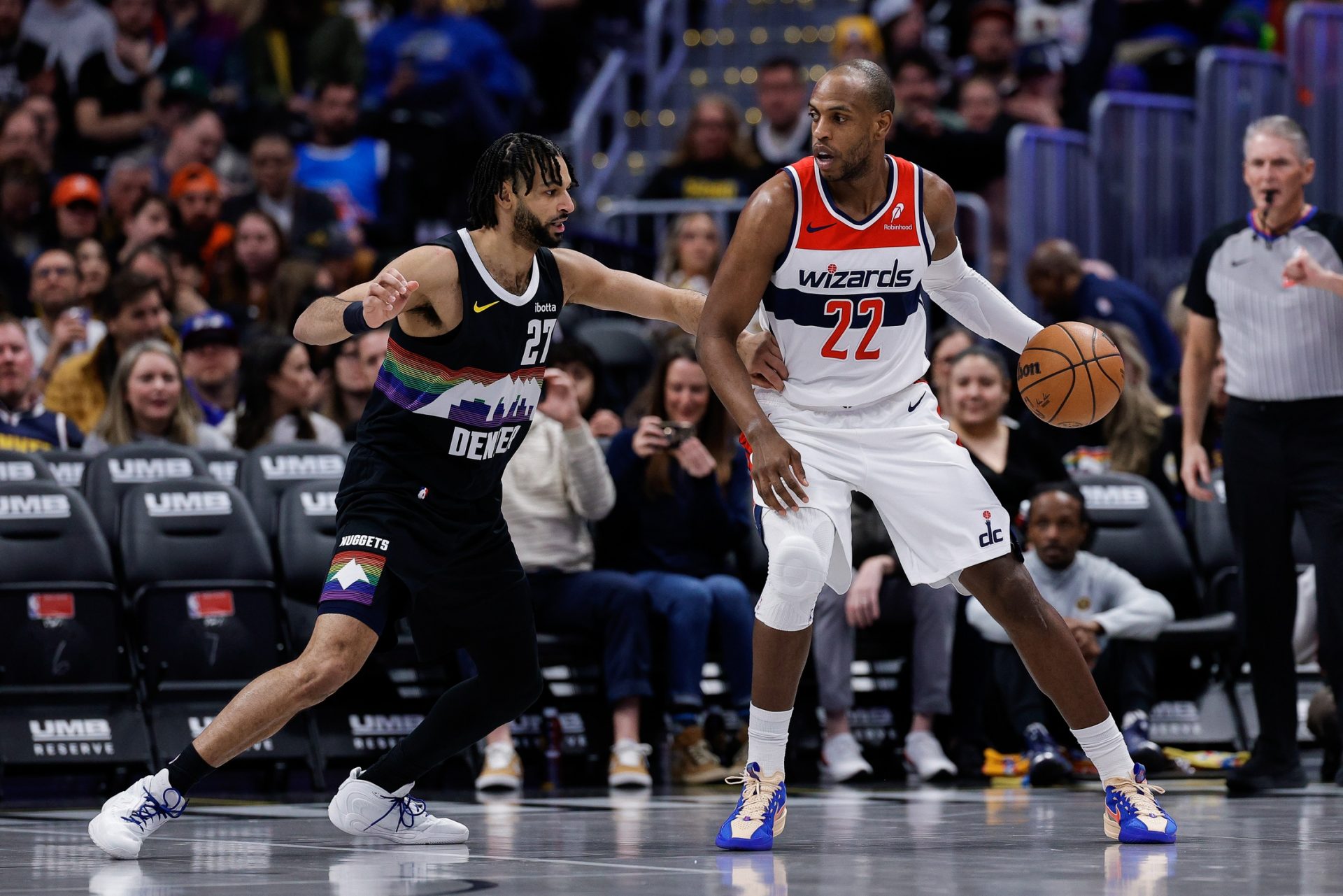 Washington Wizards forward Khris Middleton (22) controls the ball as Denver Nuggets guard Jamal Murray (27) guards in the first quarter at Ball Arena.
