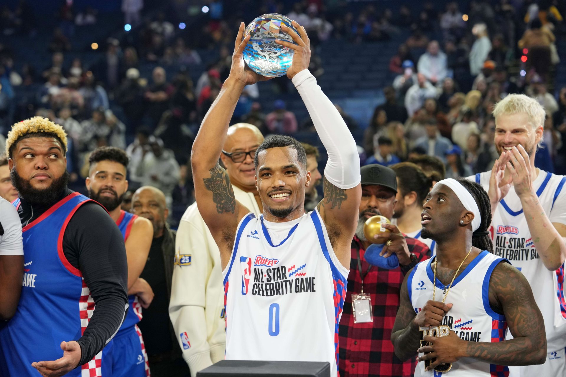 Rome Flynn (0) of Team Bonds holds up the MVP trophy after the celebrity game ahead of the 2025 NBA All Star Game at Oakland Arena.