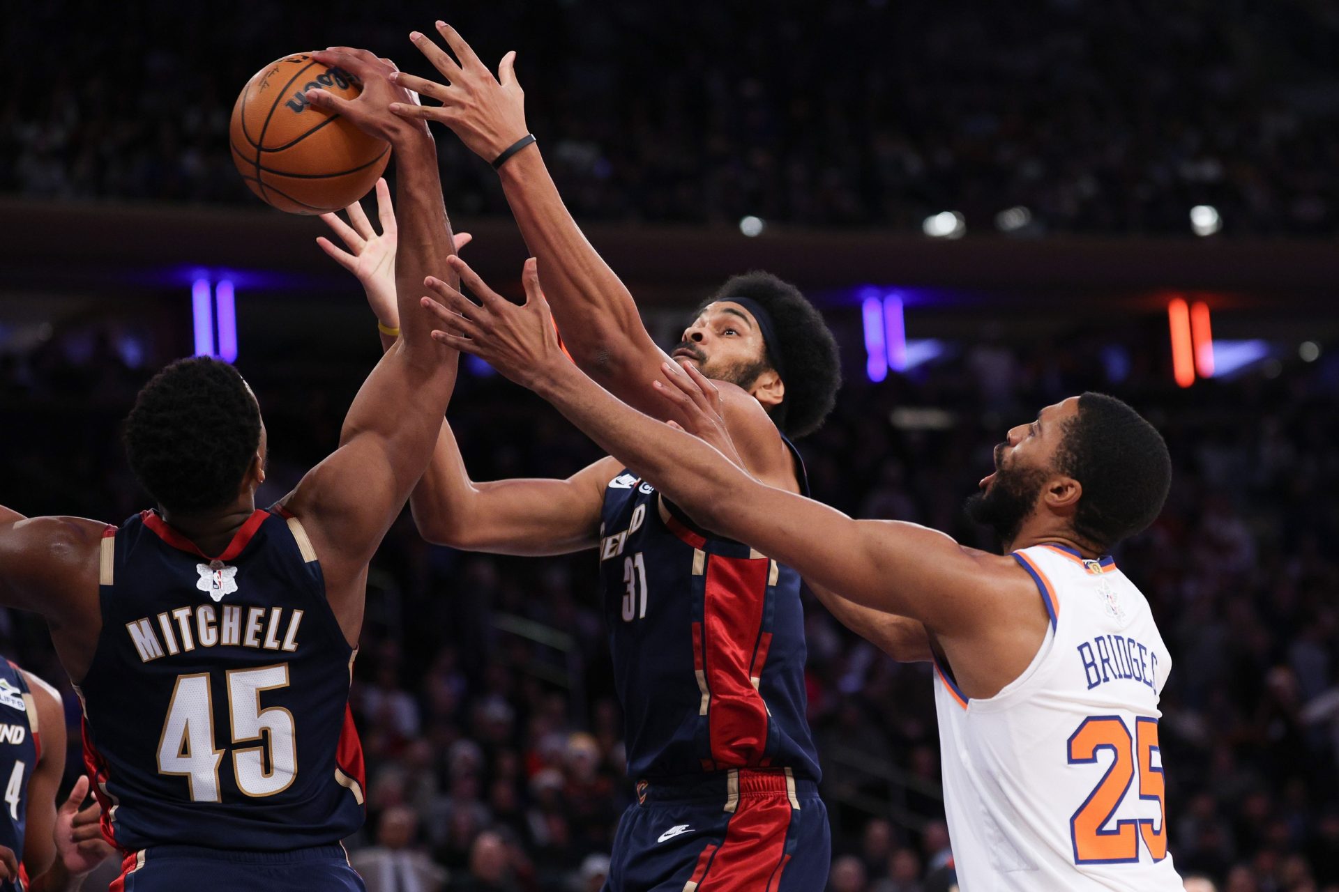 Cleveland Cavaliers center Jarrett Allen (31) and guard Donovan Mitchell (45) rebound against New York Knicks guard Mikal Bridges (25) during the second half at Madison Square Garden.