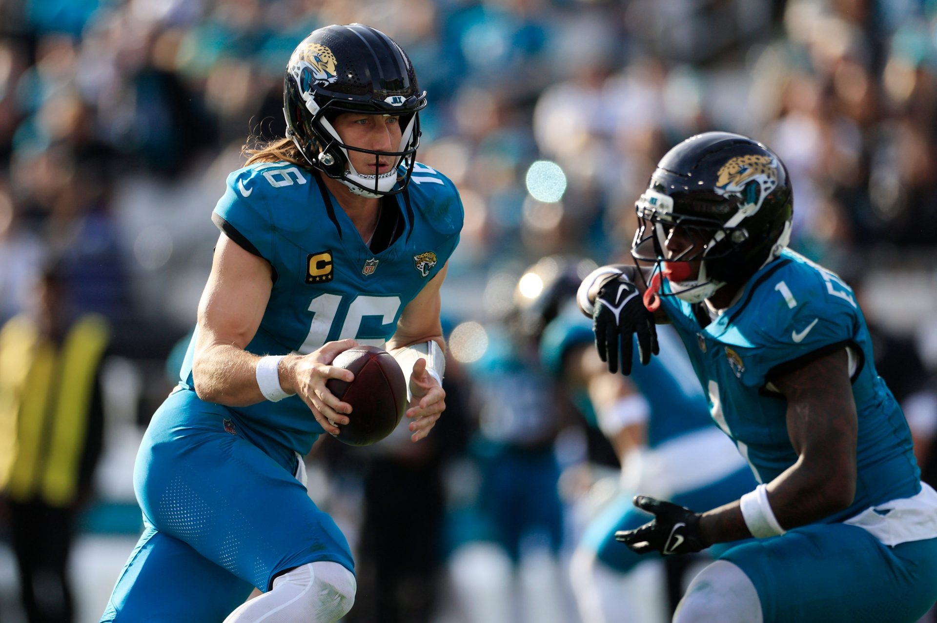 Jacksonville Jaguars quarterback Trevor Lawrence (16) fakes the hands off to running back Travis Etienne Jr. (1) during the fourth quarter of an NFL football AFC Wild Card playoff matchup, Sunday, Jan. 11, 2026, in Jacksonville, Fla. The Bills defeated the Jaguars 27-24. [Corey Perrine/Florida Times-Union]