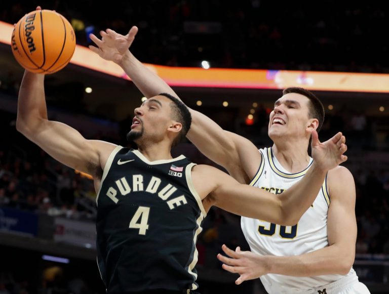 Purdue Boilermakers forward Trey Kaufman-Renn (4) grabs a rebound over Michigan Wolverines center Vladislav Goldin (50) Friday, March 14, 2025, during the Big Ten Menâ€™s Basketball Tournament game at Gainbridge Fieldhouse in Indianapolis.