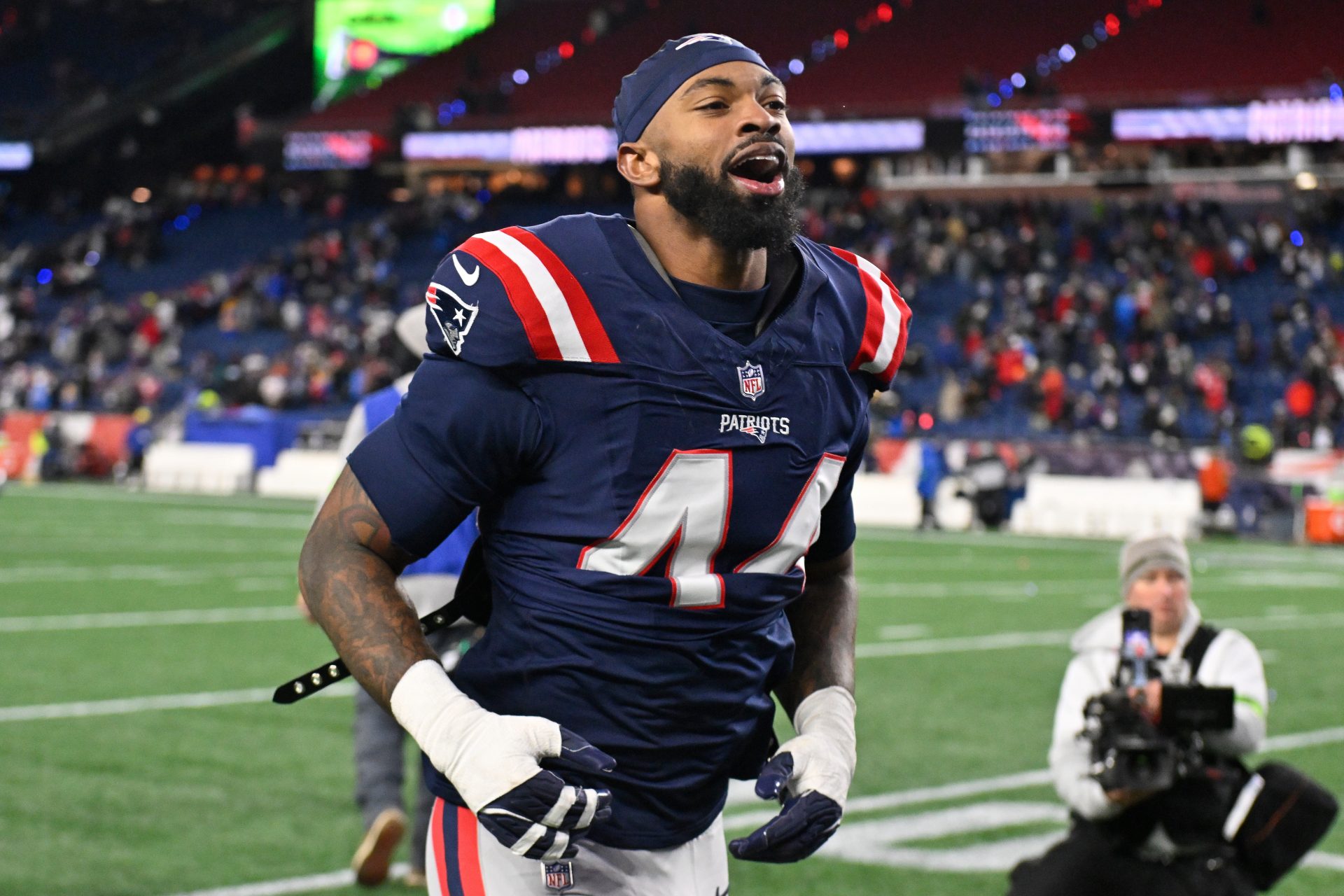 New England Patriots linebacker K'Lavon Chaisson (44) jogs off the field after defeating the Los Angeles Chargers in an AFC Wild Card Round game at Gillette Stadium.