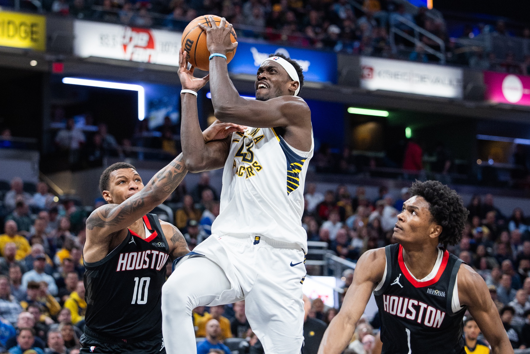 Indiana Pacers forward Pascal Siakam (43) shoots the ball while Houston Rockets forward Jabari Smith Jr. (10) and forward Amen Thompson (1)  defend in the second half at Gainbridge Fieldhouse.