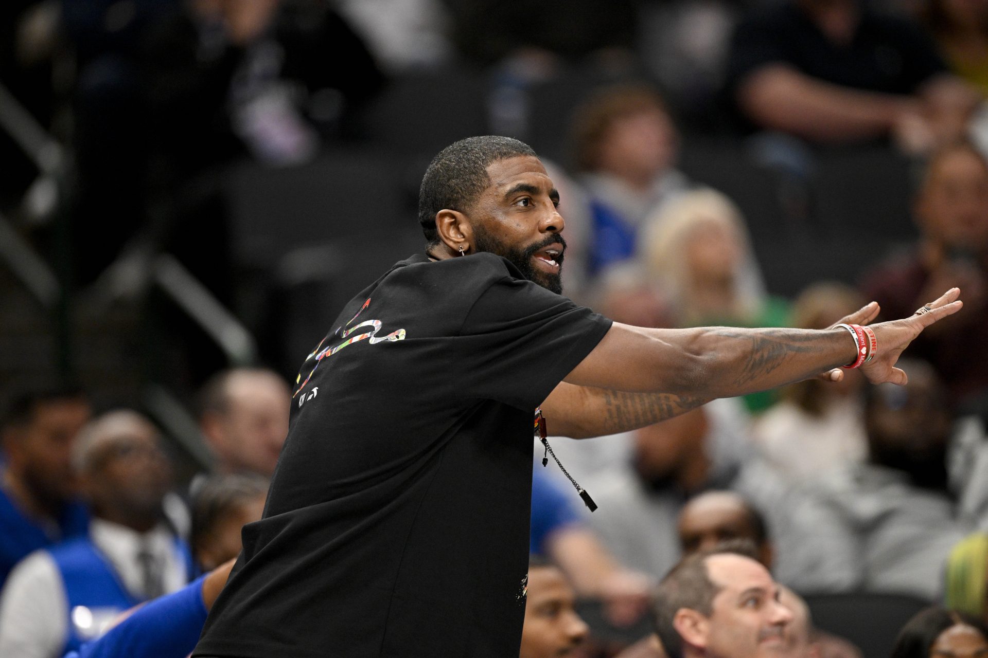 Dallas Mavericks guard Kyrie Irving (11) motions to his teammates during the game between the Mavericks and the Nets at the American Airlines Center.
