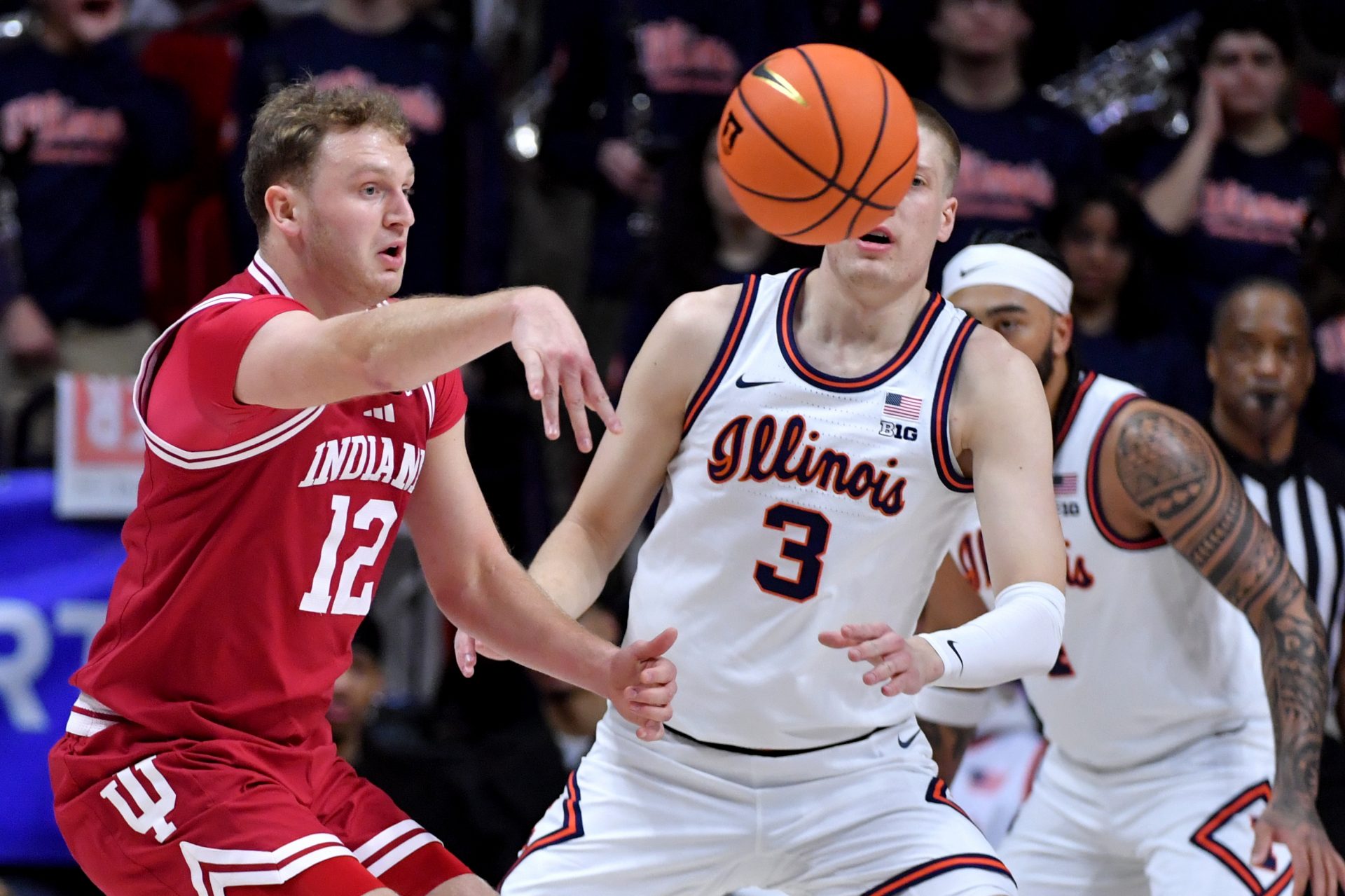 Indiana Hoosiers forward Tucker DeVries (12) passes the b all by Illinois Fighting Illini forward Ben Humrichhous (3) during the first half at State Farm Center.