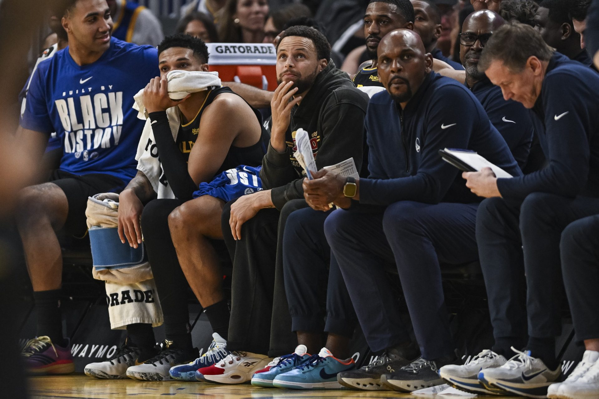 Golden State Warriors guard Stephen Curry (30) looks on from the bench during the second period against the Philadelphia 76ers at Chase Center.