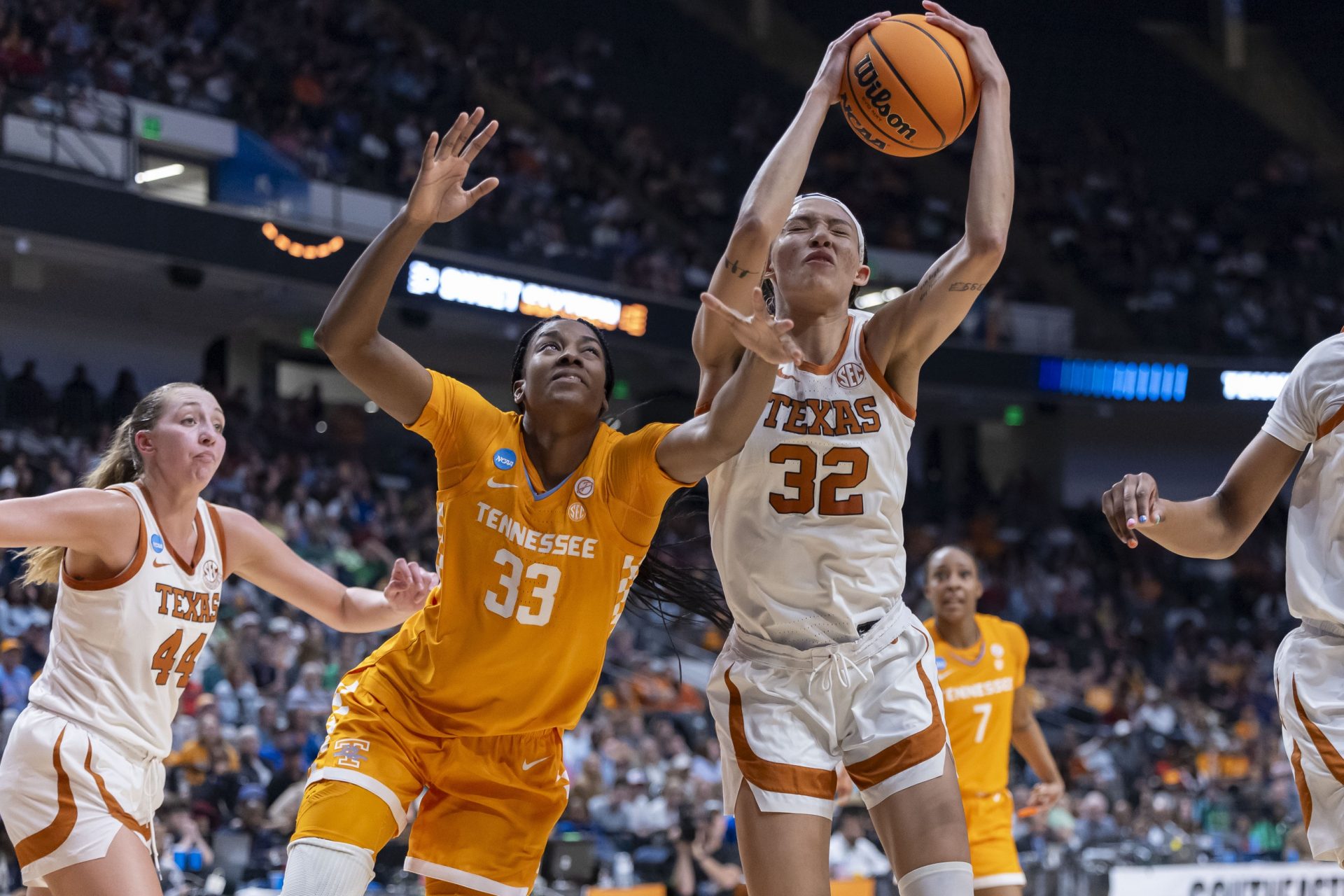 Tennessee Lady Vols forward Alyssa Latham (33) and Texas Longhorns guard Ndjakalenga Mwenentanda (32) chase a rebound during the second half of a Sweet 16 NCAA Tournament basketball game at Legacy Arena.