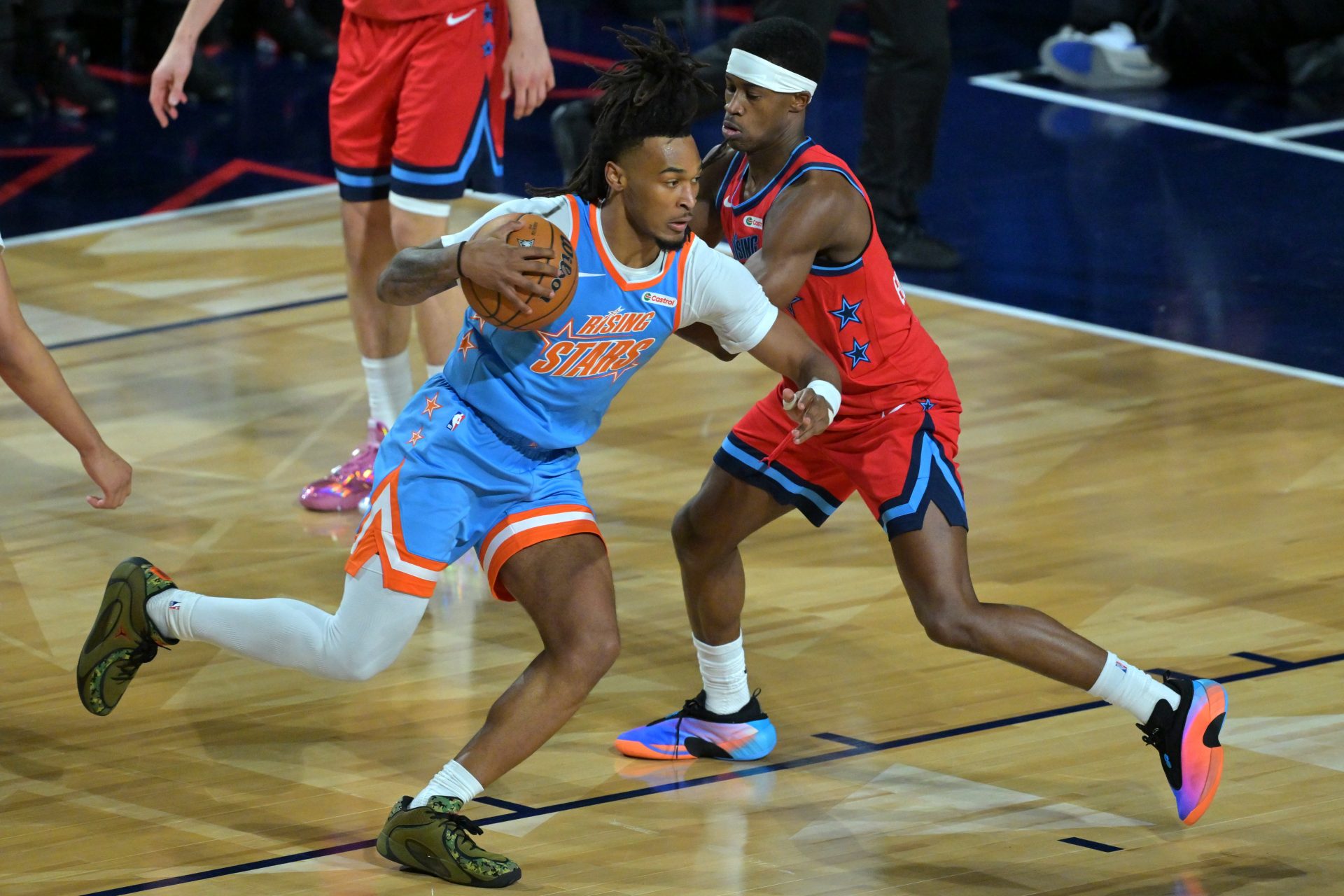 Team Vince guard VJ Edgecombe (77) of the Philadelphia 76ers defends against Team Melo guard Stephon Castle (5) of the San Antonio Spurs during an NBA All Star Rising Stars championship game at Intuit Dome.