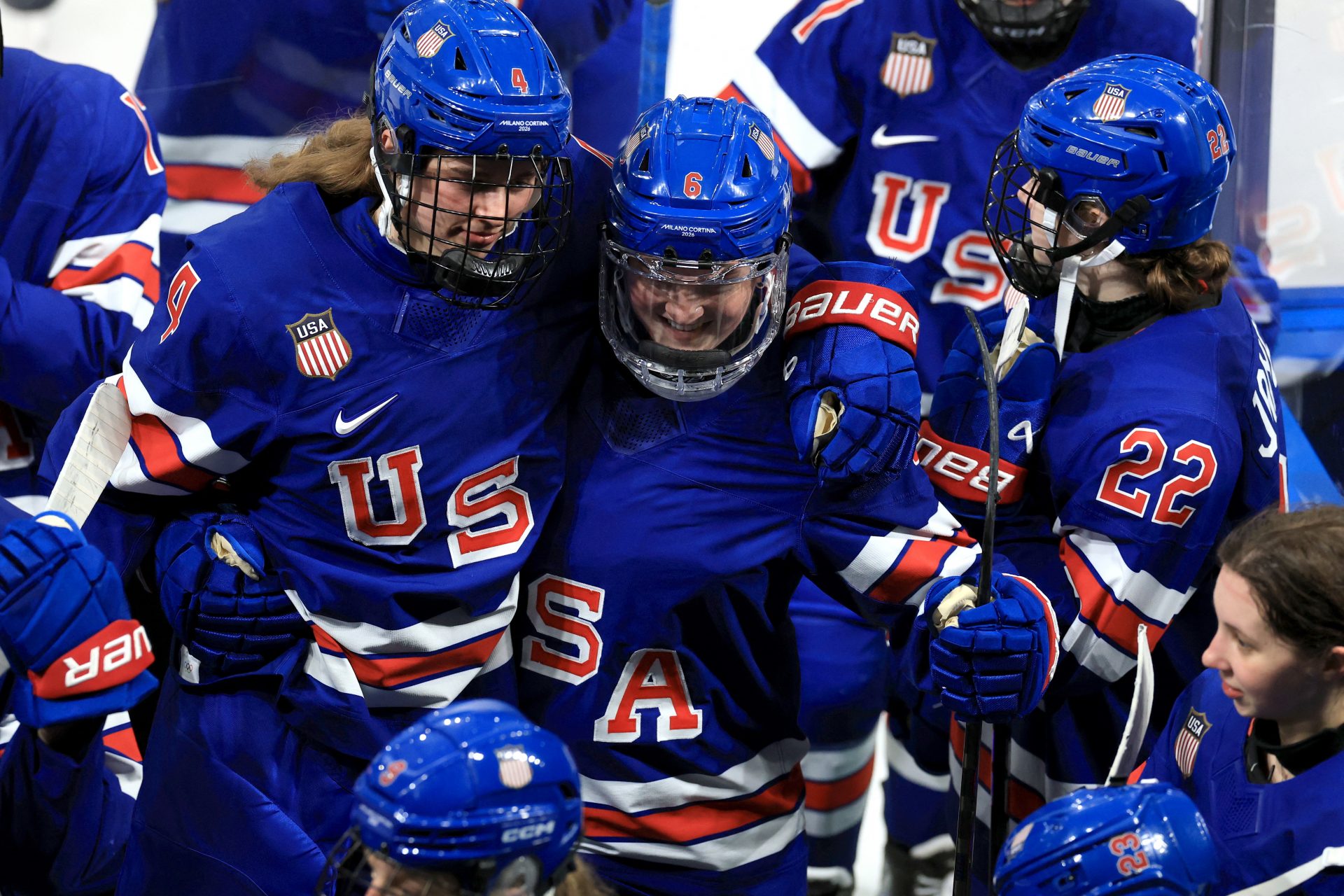 United States players celebrate at the end of the match against Italy in a women's ice hockey quarterfinal during the Milano Cortina 2026 Olympic Winter Games at Milano Rho Ice Hockey Arena.