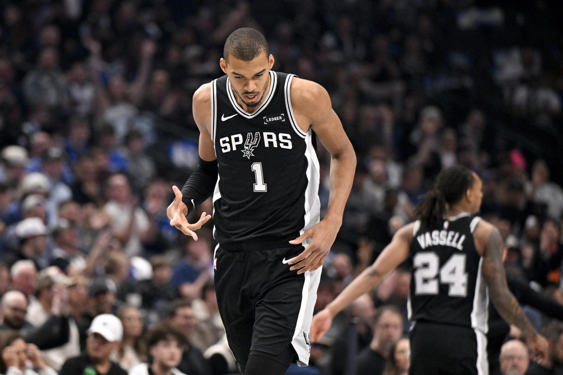 San Antonio Spurs forward Victor Wembanyama (1) celebrates after making a three point basket against the Dallas Mavericks during the first quarter at the American Airlines Center.