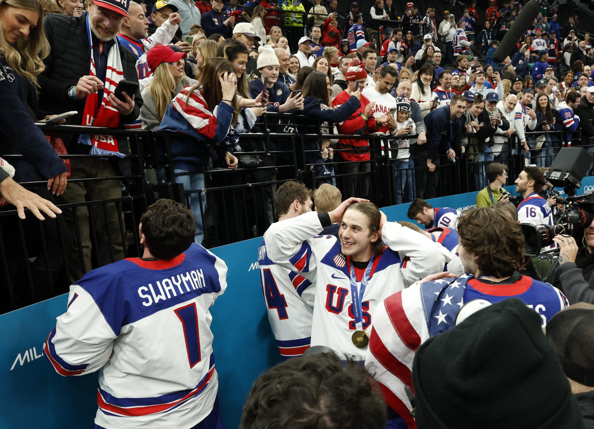 Jack Hughes (86) of the United States celebrates with fans after defeating Canada in the men's ice hockey gold medal game during the Milano Cortina 2026 Olympic Winter Games at Milano Santagiulia Ice Hockey Arena.