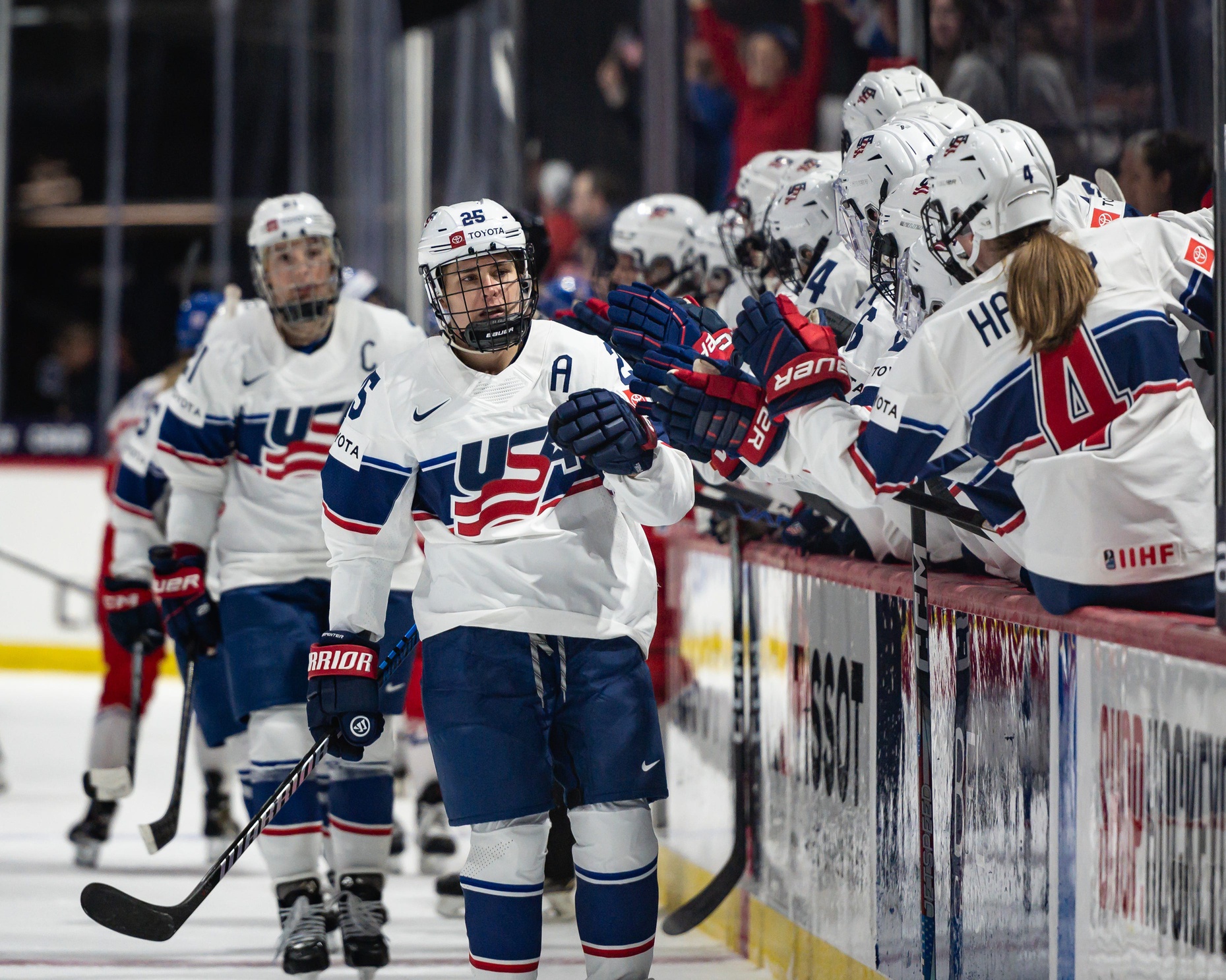 USA's Alex Carpenter celebrates with teammates after scoring against Czechia at the Adirondack Bank Center in Utica, NY on Friday, April 5, 2024.