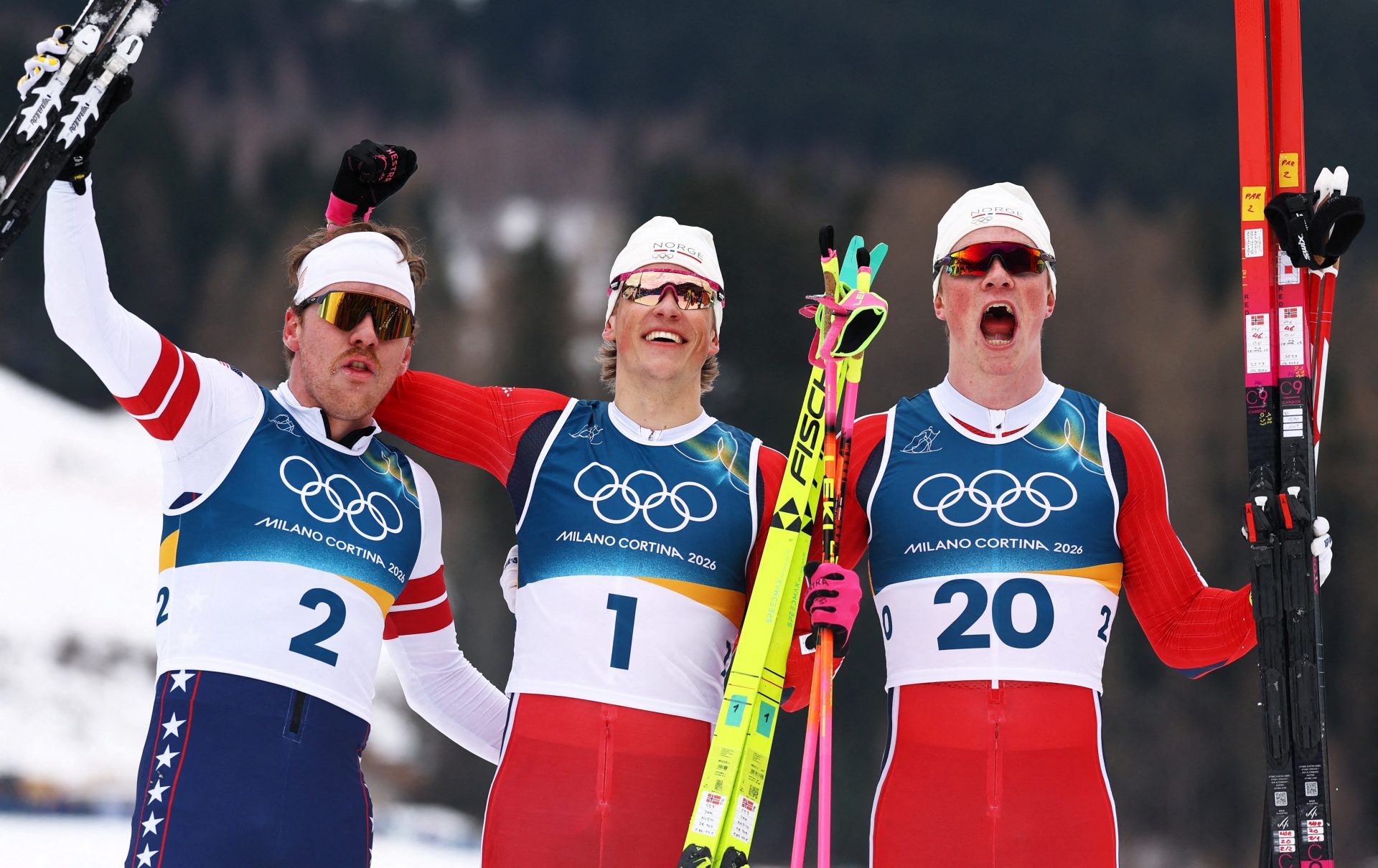 [US, Mexico & Canada customers only] Feb 10, 2026; Tesero, Italy; Johannes Hoesflot Klaebo of Norway celebrates with second placed Ben Ogden of United States and third placed Oskar Opstad Vike of Norway in the men's cross country skiing sprint classic final during the Milano Cortina 2026 Olympic Winter Games at Tesero Cross-Country Skiing Stadium.