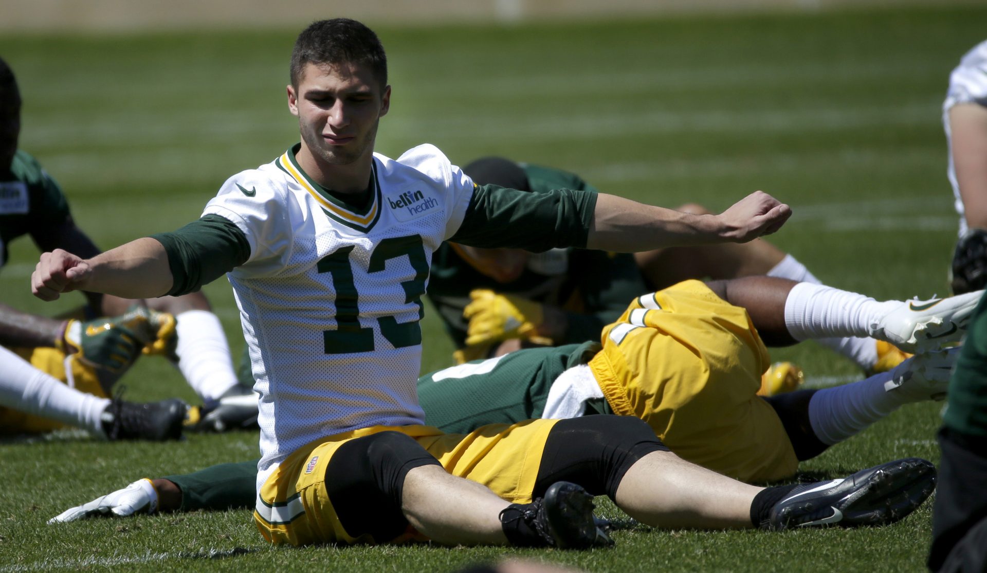 Green Bay Packers wide receiver Max McCaffrey (13) stretches during organized team activities.