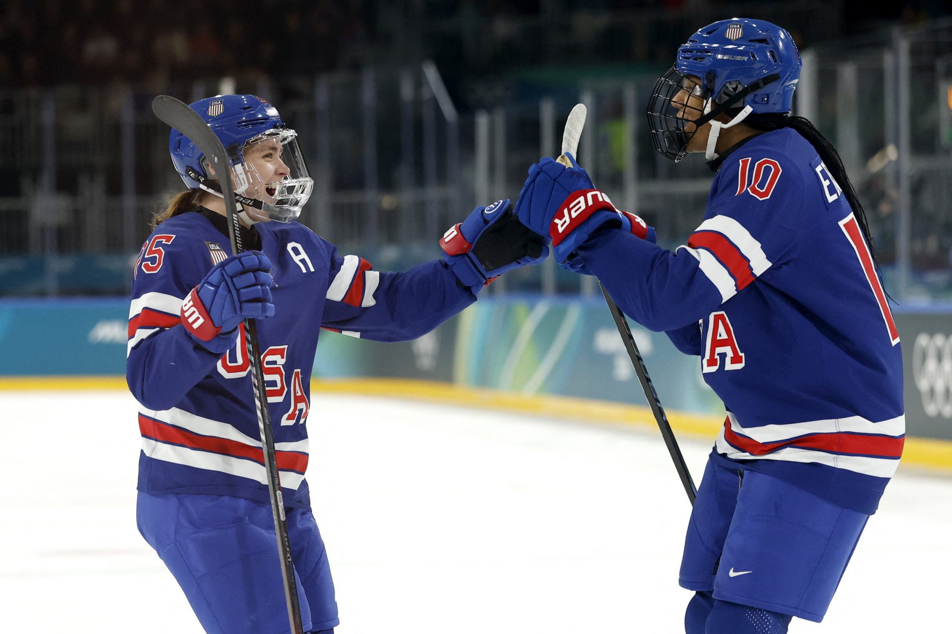 Alex Carpenter (25) of the United States celebrates with Laila Edwards (10) of the United States after scoring a goal against Finland in women's ice hockey group A play during the Milano Cortina 2026 Olympic Winter Games at Milano Rho Ice Hockey Arena.