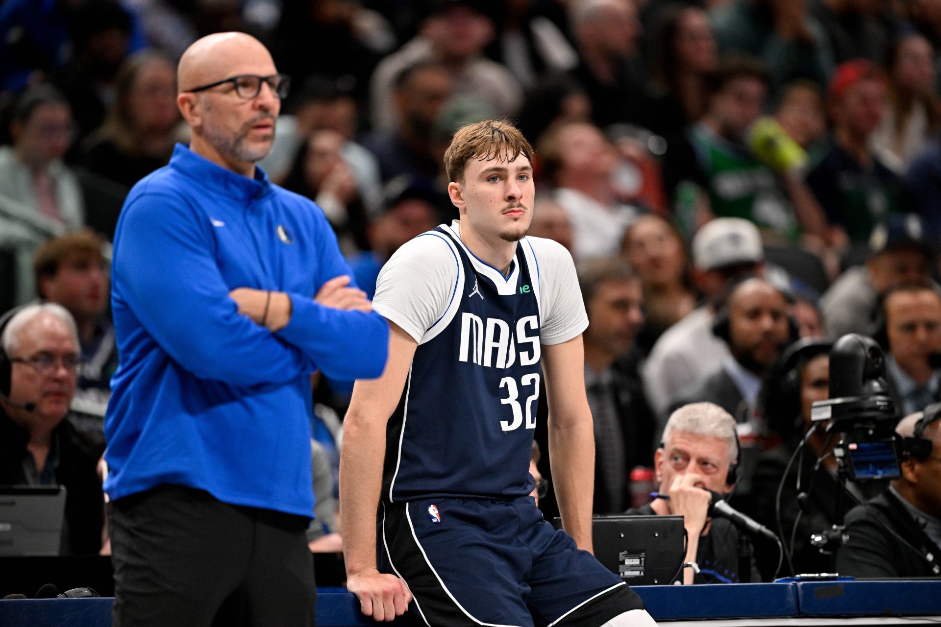 Dallas Mavericks head coach Jason Kidd and forward Cooper Flagg (32) look on during the game between the Mavericks and the 76ers at American Airlines Center.