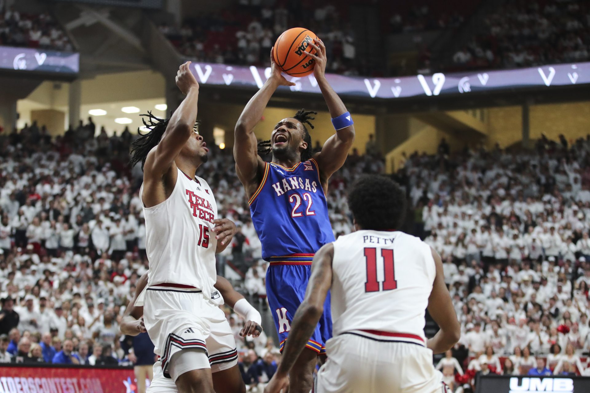 Kansas Jayhawks guard Darryn Peterson (22) goes to the basket against Texas Tech Red Raiders forward JT Toppin (15) in the first half at United Supermarkets Arena.