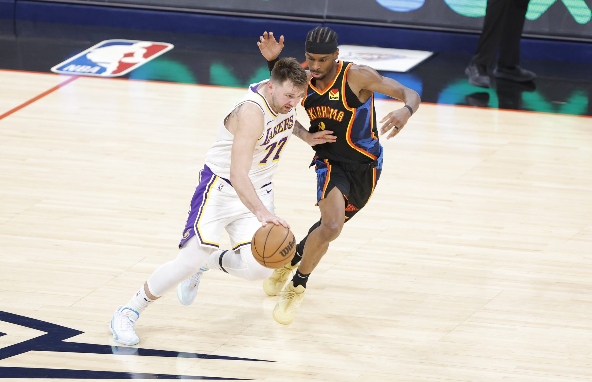 Los Angeles Lakers guard Luka Doncic (77) drives down the court beside Oklahoma City Thunder guard Shai Gilgeous-Alexander (2). - Source: Imagn