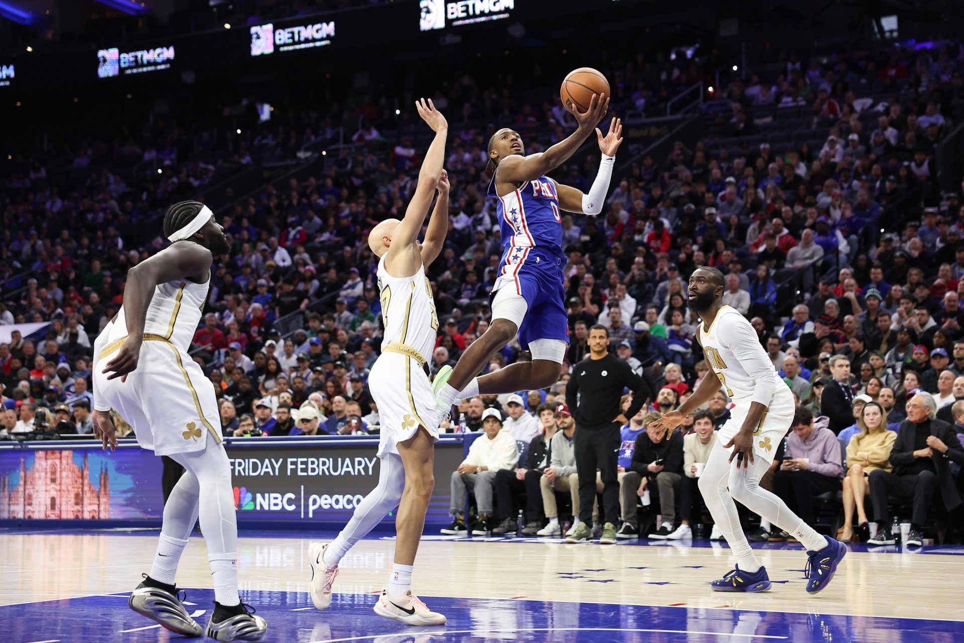 Philadelphia 76ers guard Tyrese Maxey (0) drives for a shot against Boston Celtics guard Jordan Walsh (27) and guard Jaylen Brown (7) during the fourth quarter at Xfinity Mobile Arena Source - Imagn Images