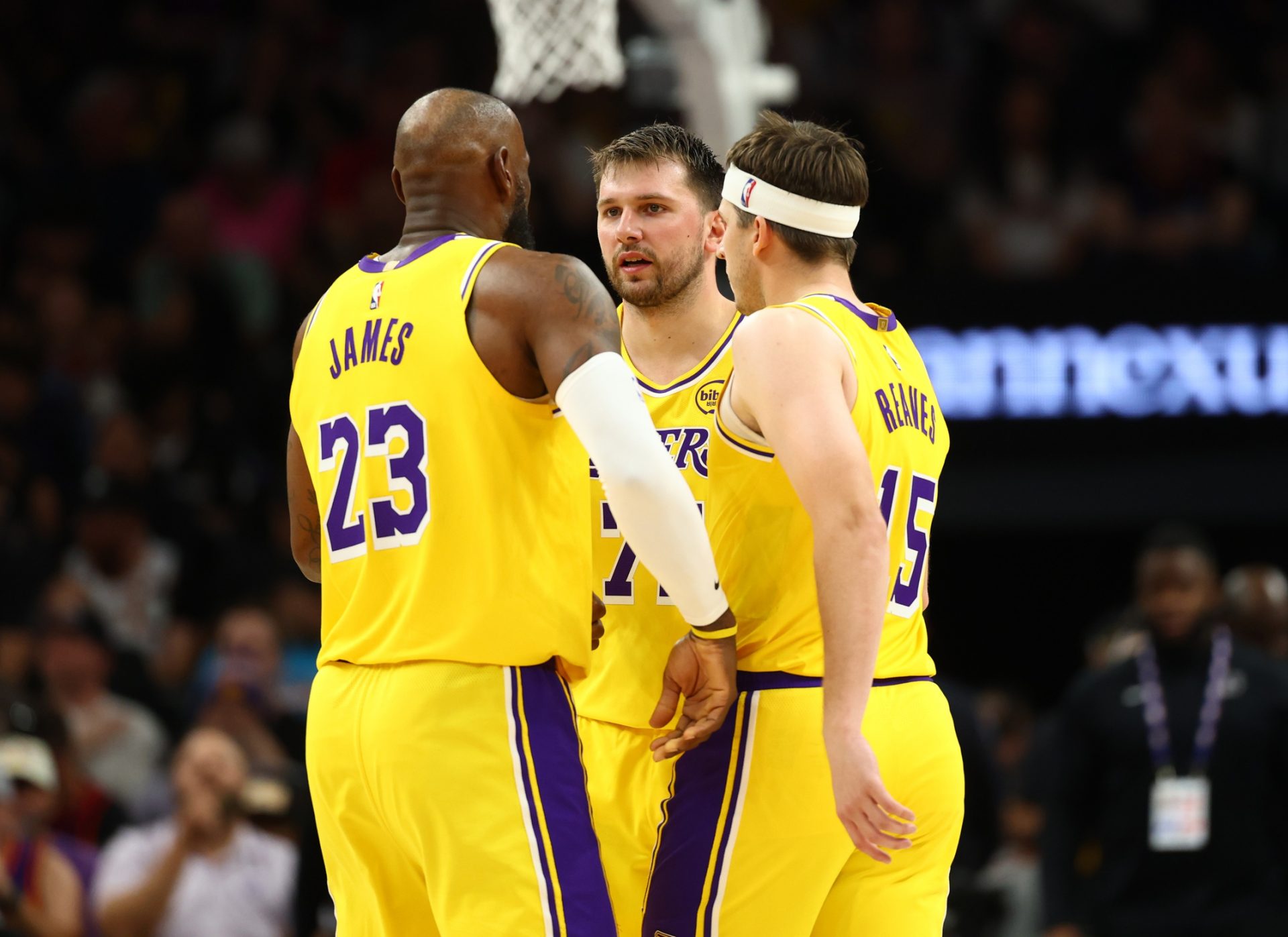 Los Angeles Lakers forward LeBron James (23) with guard Luka Doncic (77) and guard Austin Reaves (15) against the Phoenix Suns at Mortgage Matchup Center - Source: Imagn Images