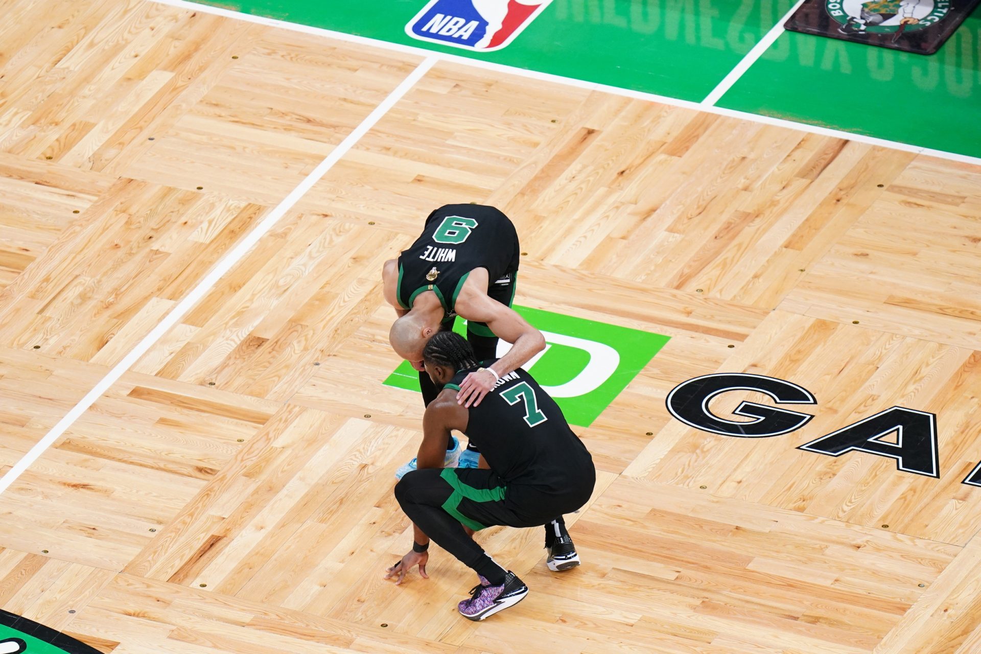 Boston Celtics guard Jaylen Brown (7) reacts with guard Derrick White (9) after defeating the Dallas Mavericks in game two of the 2024 NBA Finals at TD Garden.