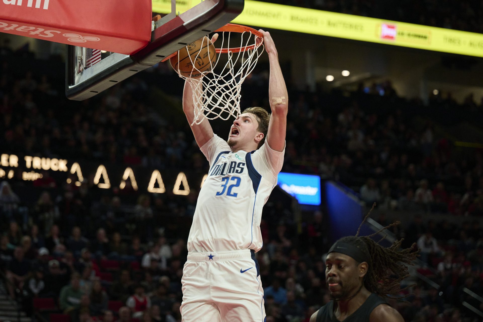Dallas Mavericks forward Cooper Flagg (32) dunks the basketball during the second half against Portland Trail Blazers guard Jrue Holiday (5) at Moda Center. - Source: Imagn