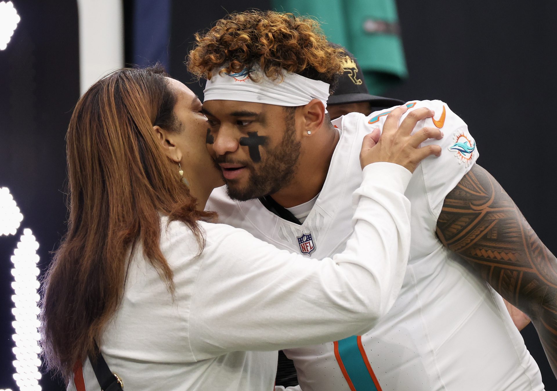 Miami Dolphins quarterback Tua Tagovailoa (1) kisses his wife Annah Gore before playing the Houston Texans at NRG Stadium - Source: Imagn