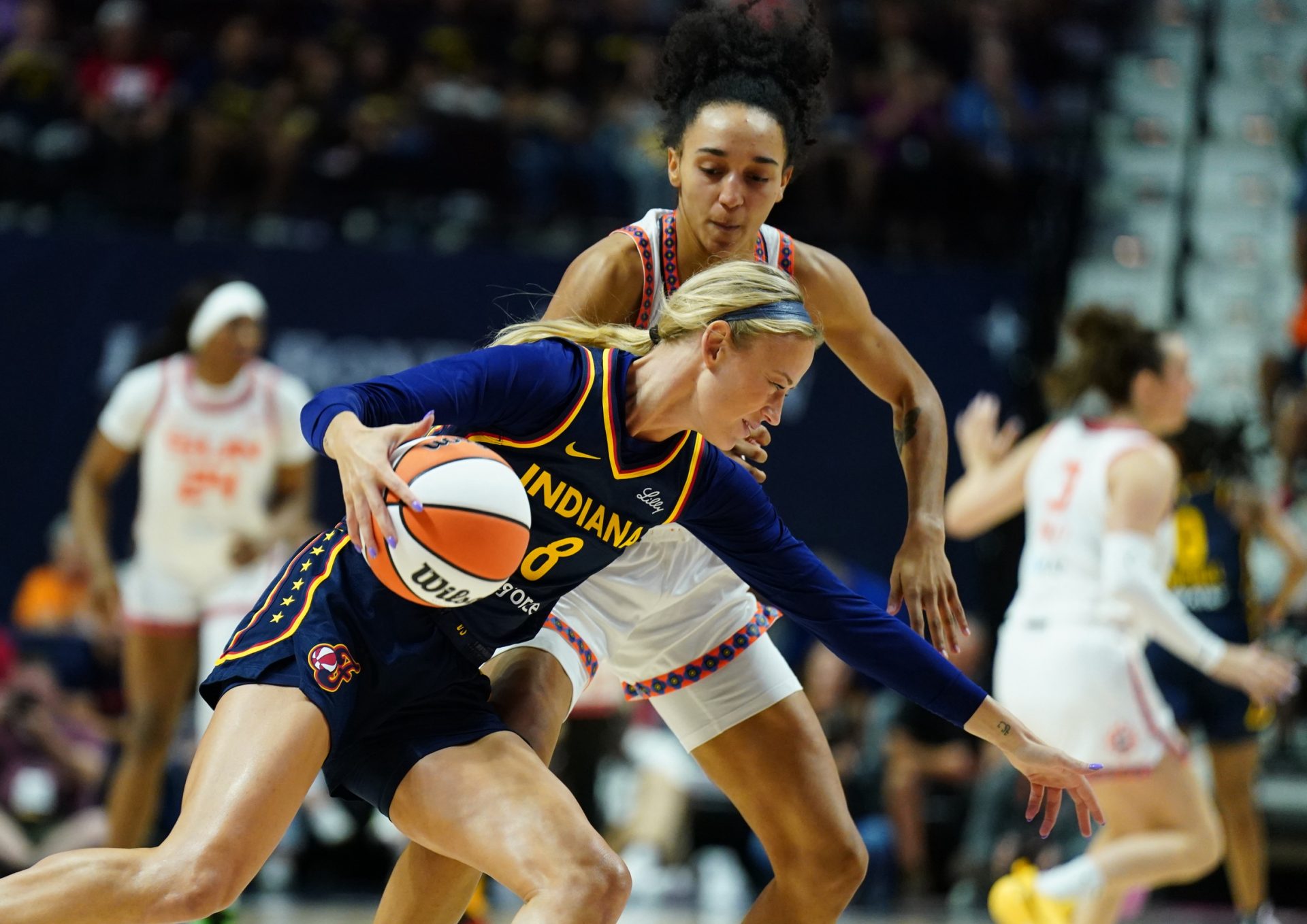 Indiana Fever guard Sophie Cunningham (8) drives the ball against Connecticut Sun guard Leila Lacan (47) in the first half at Mohegan Sun Arena - Source: Imagn Images