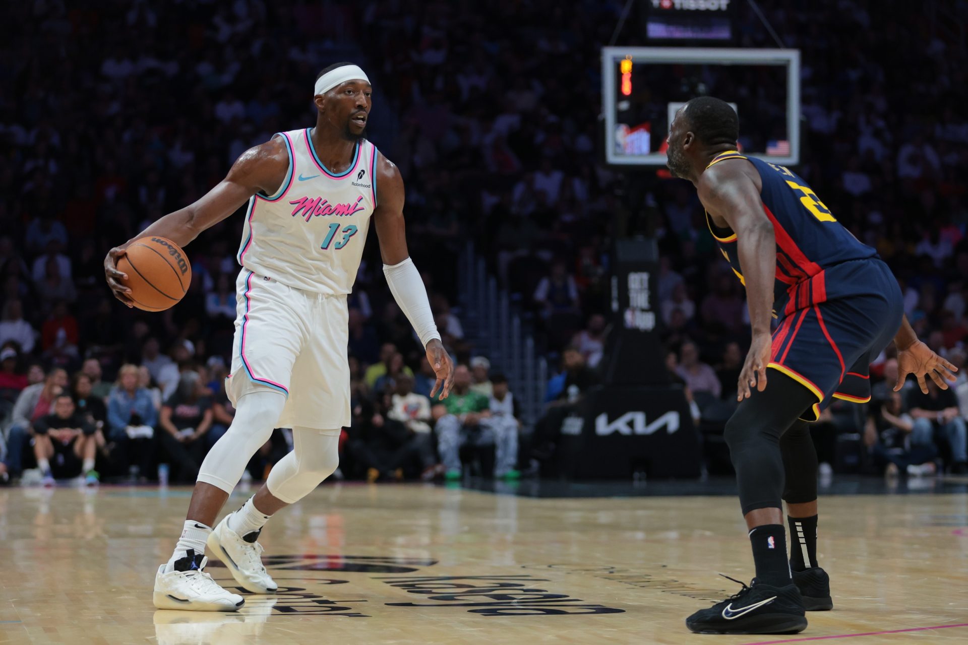 Miami Heat center Bam Adebayo (13) dribbles the basketball as Golden State Warriors forward Draymond Green (23) defends during the third quarter at Kaseya Center - Source: Imagn Images