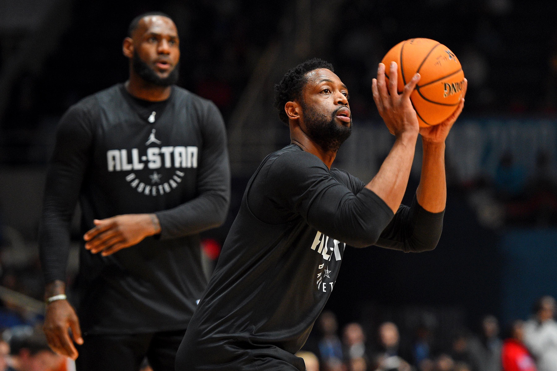 Team LeBron guard Dwayne Wade of the Miami Heat (3) shoots the ball as Team LeBron forward LeBron James of the Los Angeles Lakers (23) watches during NBA All-Star Game practice at the Bojangles Coliseum. - Source: USA Today Sports