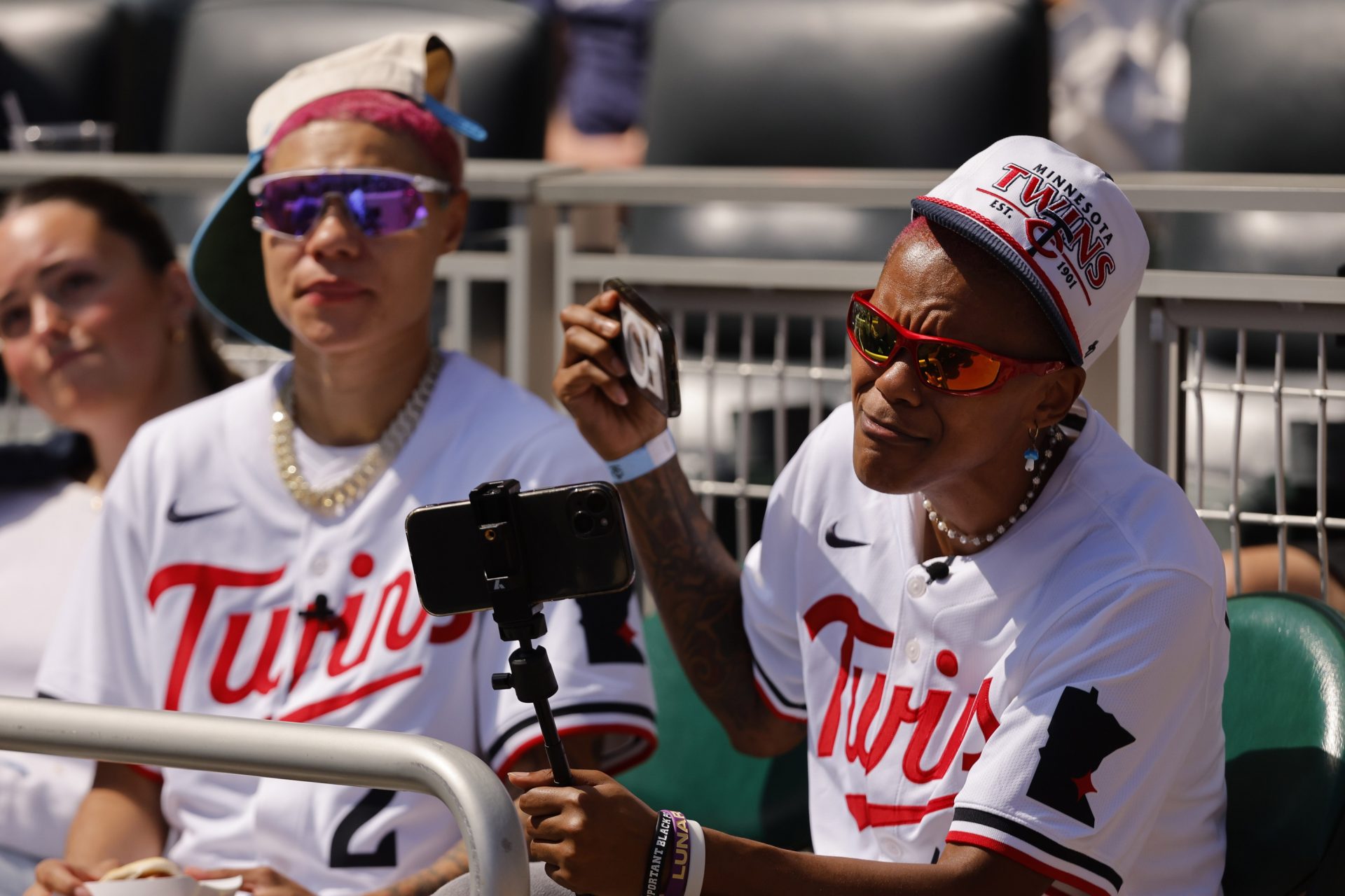 Minnesota Lynx guard Natisha Hiedeman (L) and guard Courtney Williams (R) attend the game between the San Diego Padres and the Minnesota Twins at Target Field. - Source: Imagn