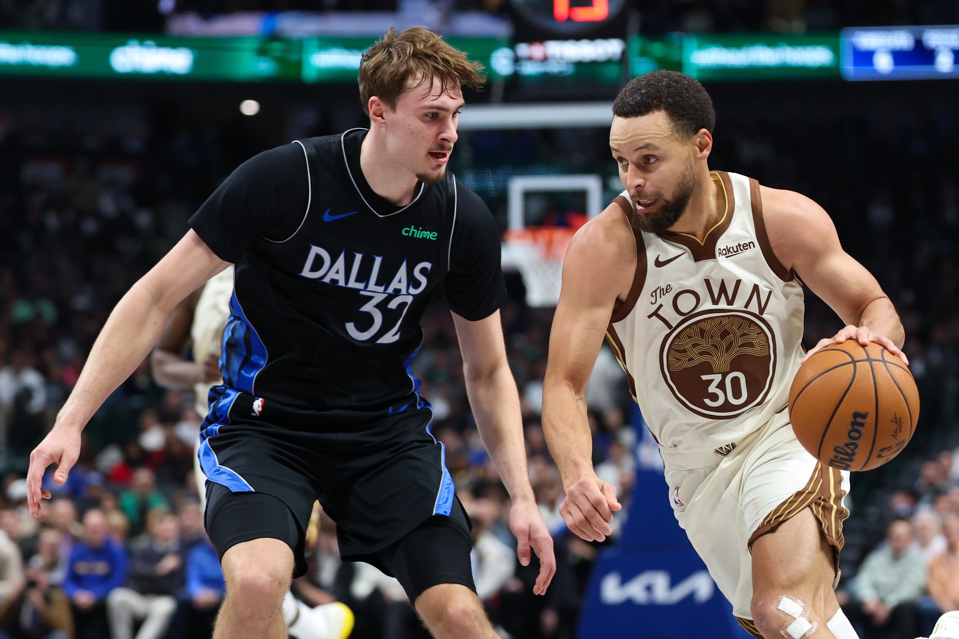 Golden State Warriors guard Stephen Curry (30) drives to the basket as Dallas Mavericks forward Cooper Flagg (32) defends  during the first half at American Airlines Center.