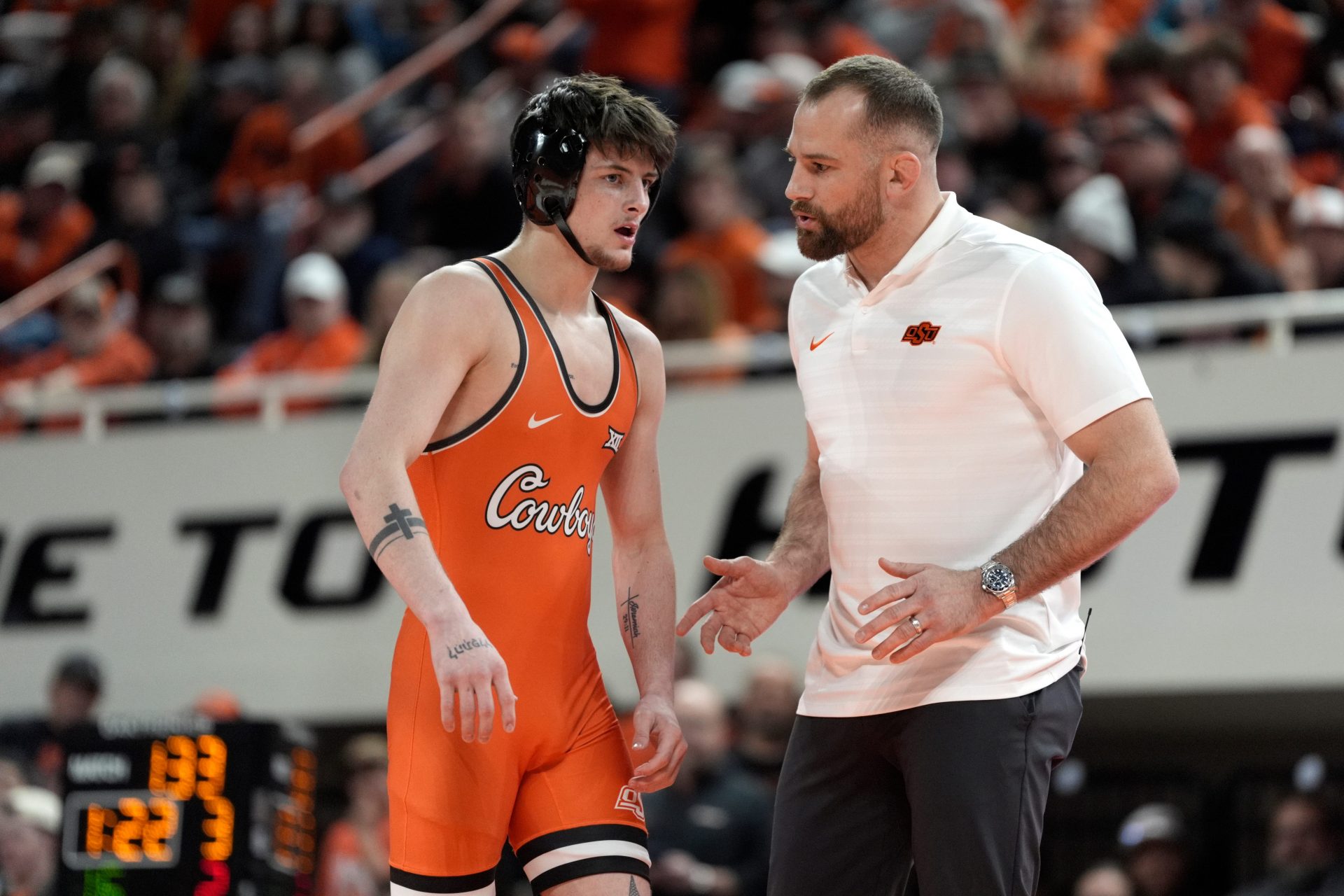 Oklahoma State's Jax Forrest talks with coach David Taylor as he wrestles Iowa's Drake Ayala at 133 pounds during a college wrestling dual between the Oklahoma State University Cowboys (OSU) and the Iowa Hawkeyes at Gallagher-Iba Arena in Stillwater, Okla., Sunday, Feb. 22, 2026 - Source: Imagn