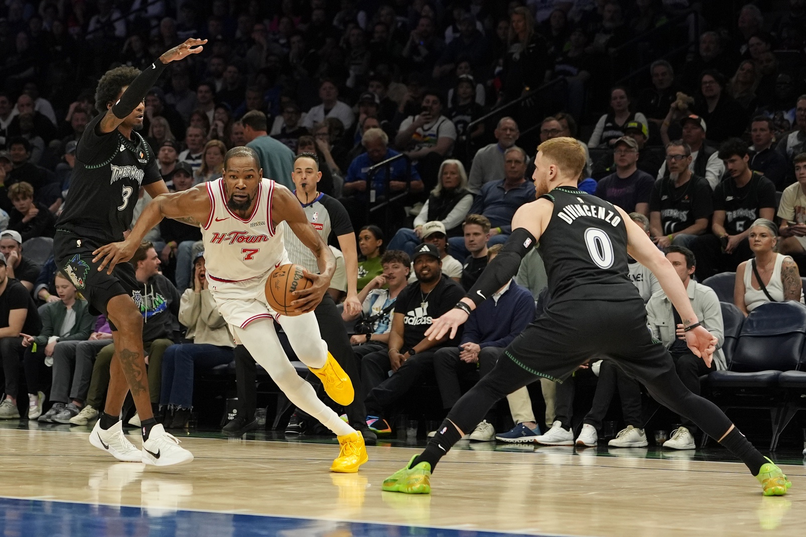 Houston Rockets forward Kevin Durant (7) goes to the basket between Minnesota Timberwolves forward Jaden McDaniels (3) and guard Donte DiVincenzo (0) in the fourth quarter at Target Center.