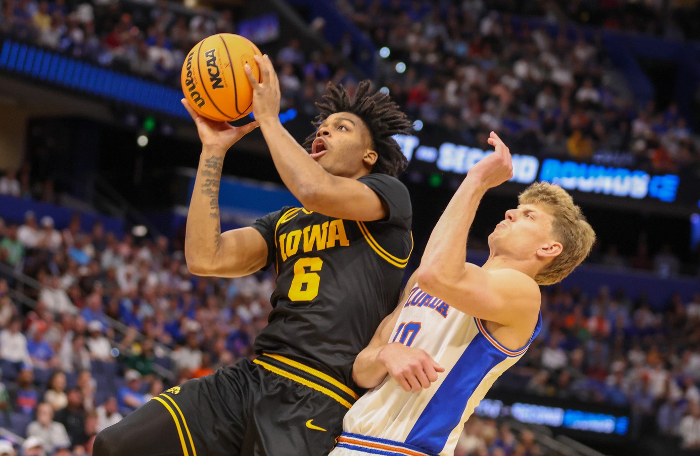 Iowa forward Cooper Koch (8) shoots past Florida forward Thomas Haugh (10) during the first half of the NCAA March Madness second round at Benchmark international Arena in Tampa, FL 
source: Imagn