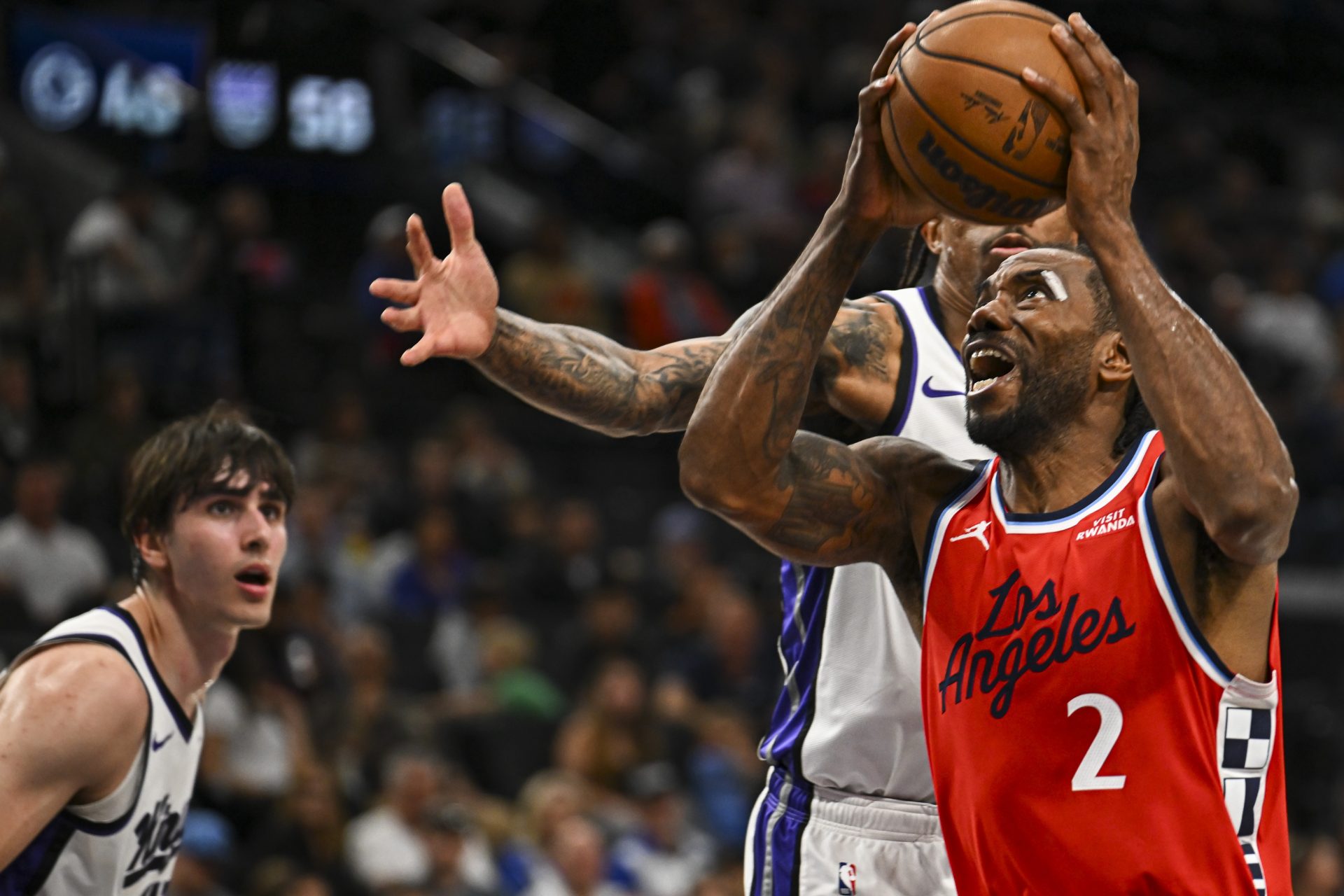 LA Clippers forward Kawhi Leonard (2) looks to shoot against Sacramento Kings guard-forward DeMar DeRozan (10), and center Maxime Raynaud (42) during the second quarter at Intuit Dome.