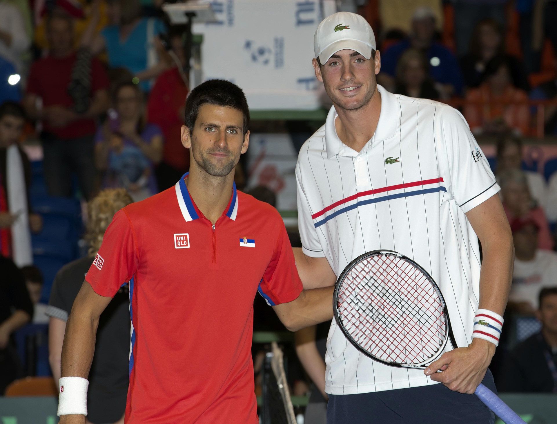 Novak Djokovic (SRB), left, poses for a photo with John Isner (USA) before a Davis Cup match at Taco Bell Arena.