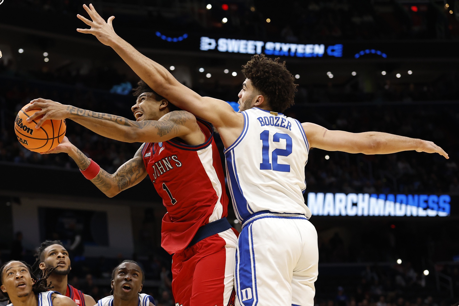 St. John's Red Storm forward Dillon Mitchell (1) shoots the ball past Duke Blue Devils forward Cameron Boozer (12) in the first half during a Sweet Sixteen game of the East Regional of the men's 2026 NCAA Tournament at Capital One Arena. Source: Imagn