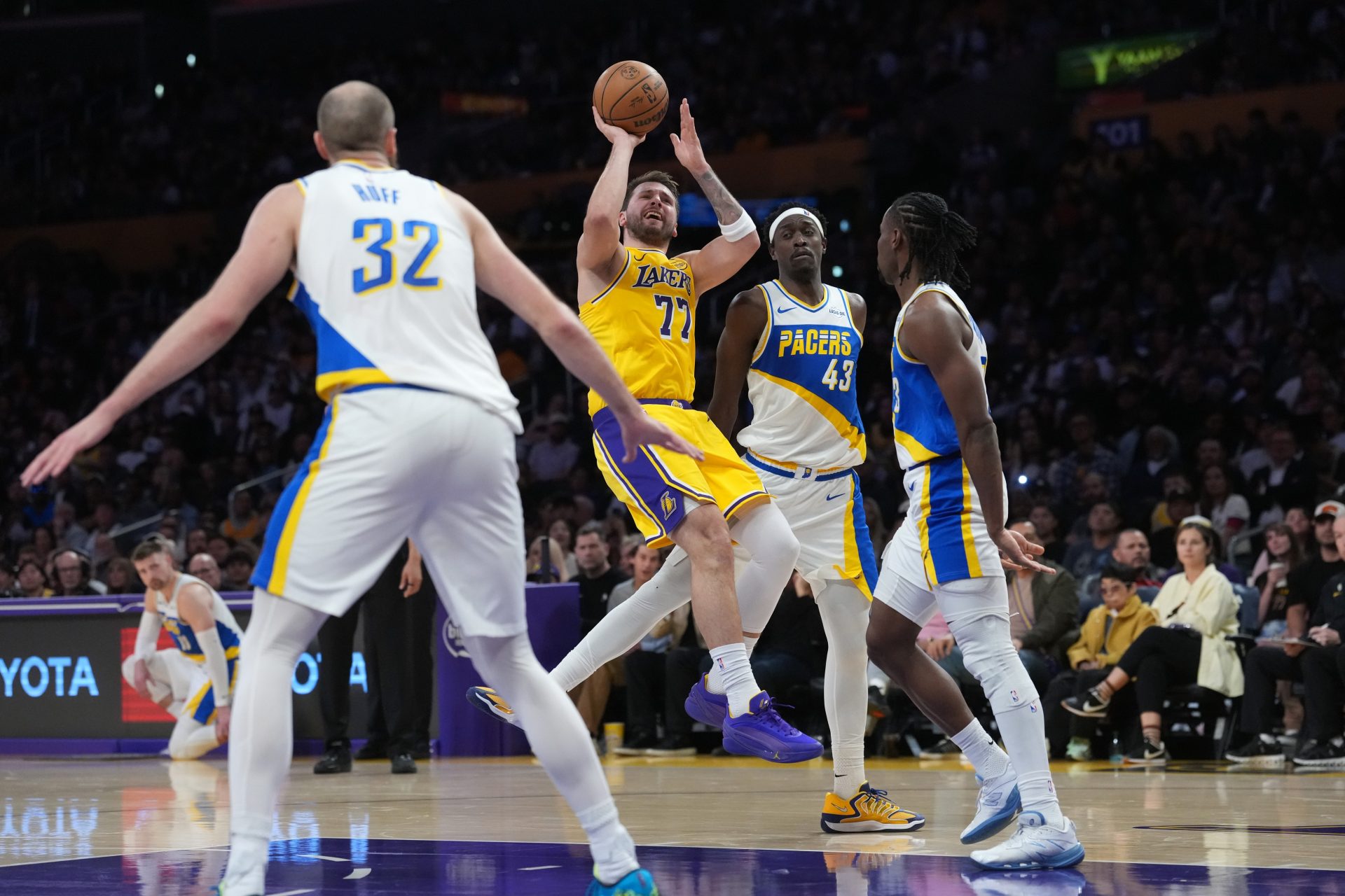 Los Angeles Lakers guard Luka Doncic (77) shoots the ball against Indiana Pacers forward Pascal Siakam (43), center Jay Huff (32) and guard Aaron Nesmith (23) in the first half at Crypto.com Arena.