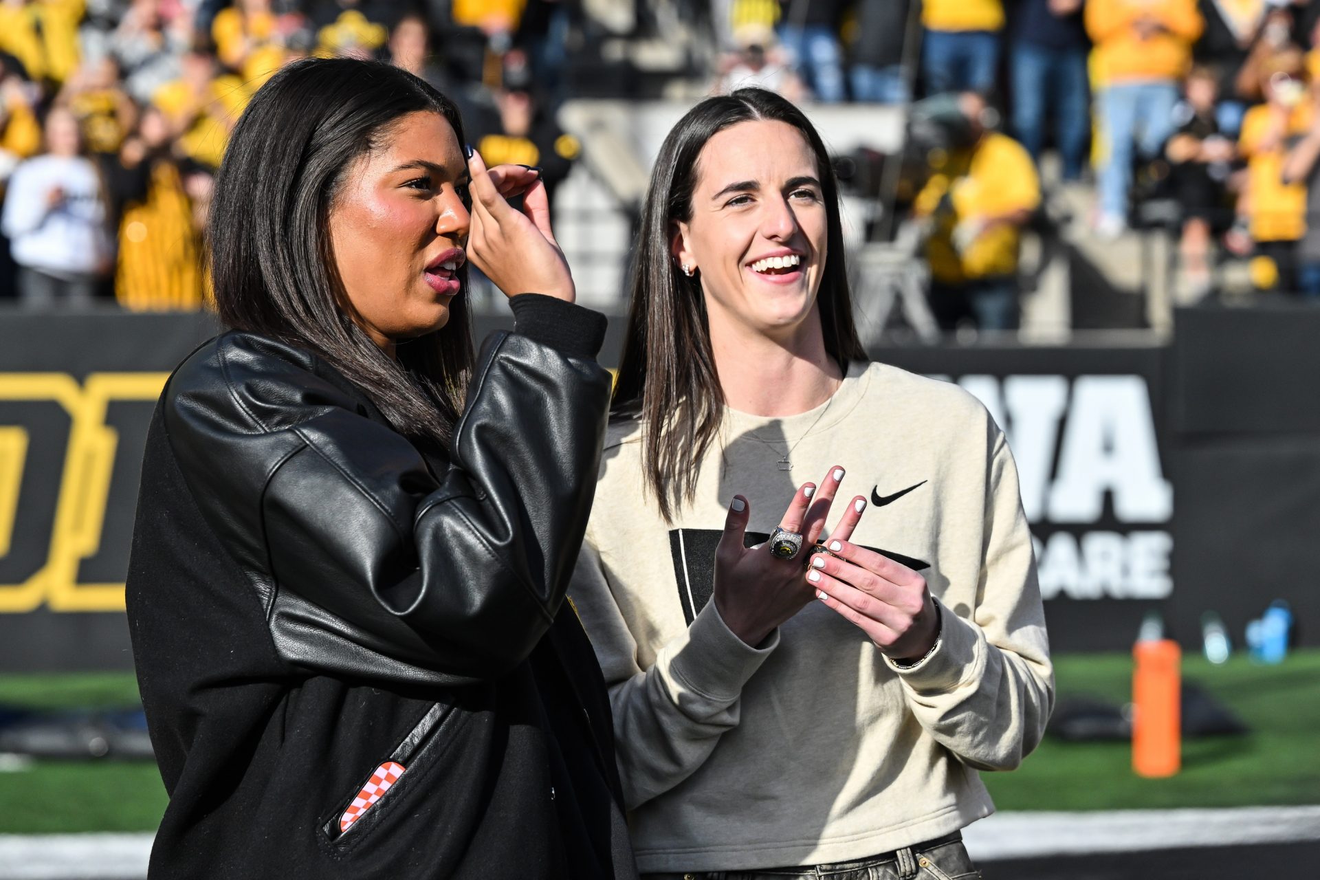 Former Iowa Hawkeye and current Indiana Fever WNBA star Caitlin Clark (right) and current Hawkeye basketball player Jada Gyamfi (left) look on while being honored during the game between the Iowa Hawkeyes and the Northwestern Wildcats at Kinnick Stadium in 2024. - Source: Imagn