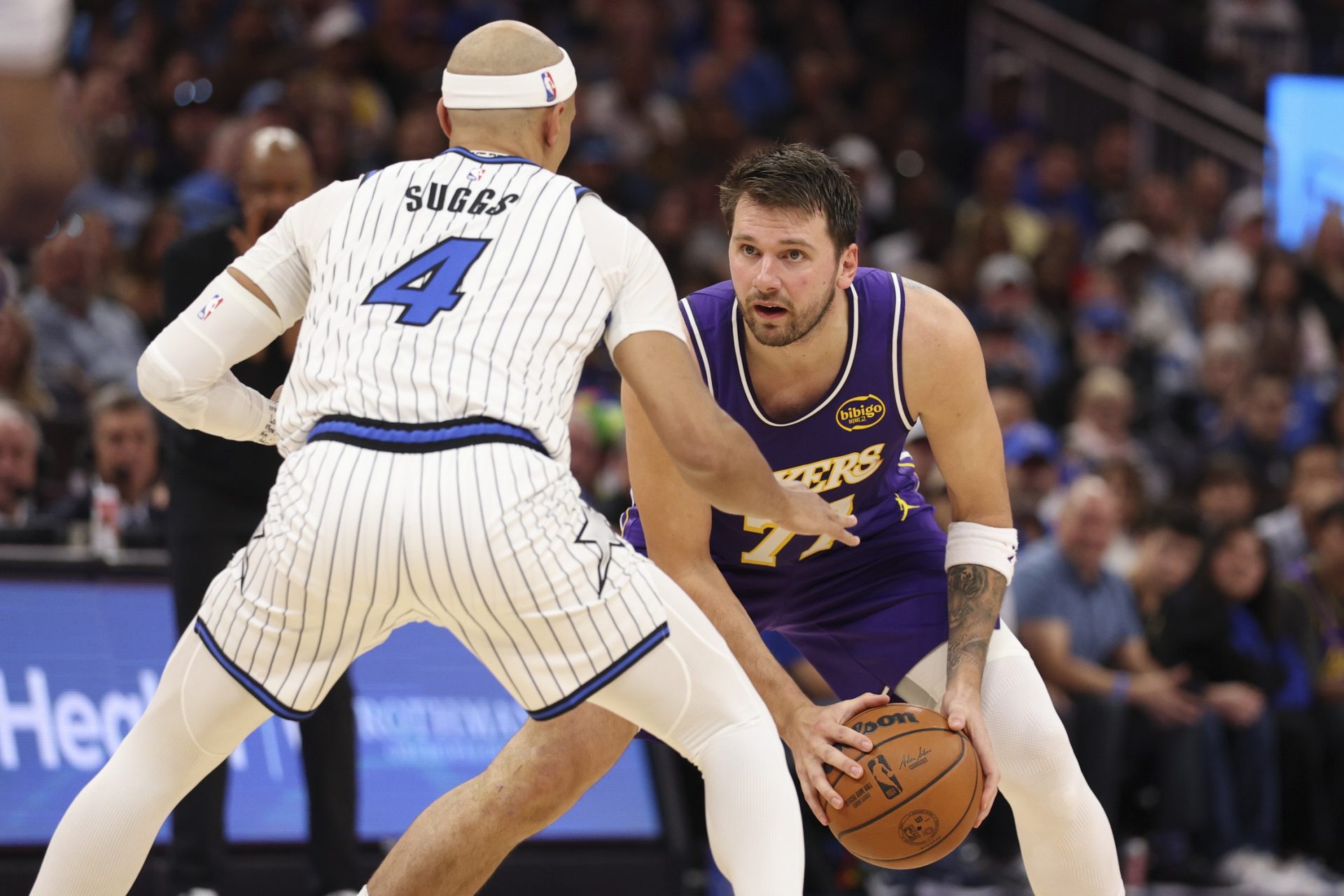 Los Angeles Lakers guard Luka Doncic (77) is guarded by Orlando Magic guard Jalen Suggs (4) in the second quarter at Kia Center. - Source: Imagn