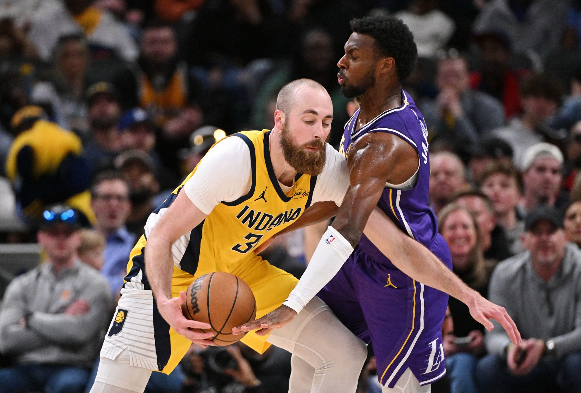 Los Angeles Lakers guard Bronny James (9) reaches for a ball controlled by Indiana Pacers center Jay Huff (32) during the second half at Gainbridge Fieldhouse.