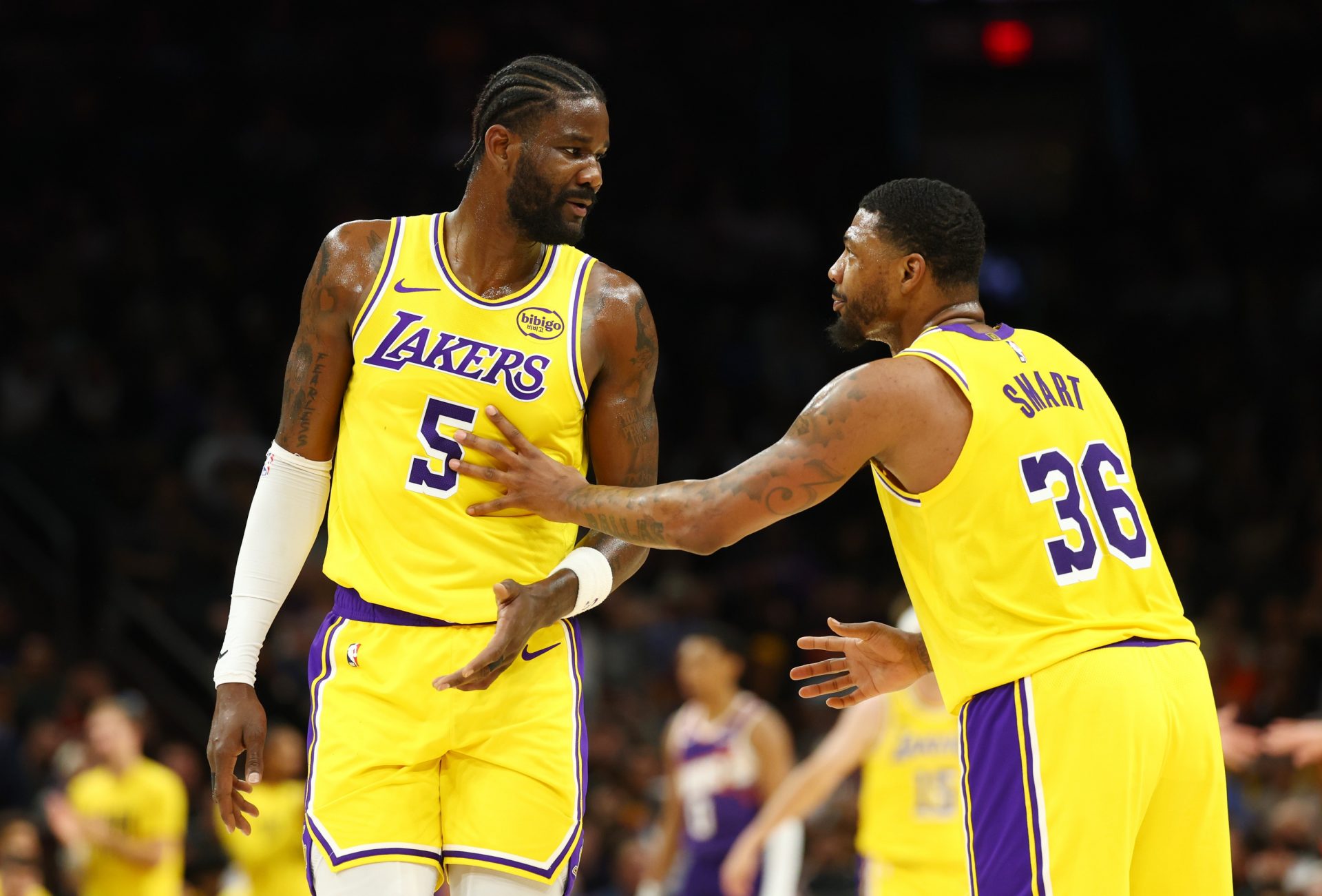 Los Angeles Lakers center Deandre Ayton (5) talks with guard Marcus Smart (36) against the Phoenix Suns at Mortgage Matchup Center - Source: Imagn Images