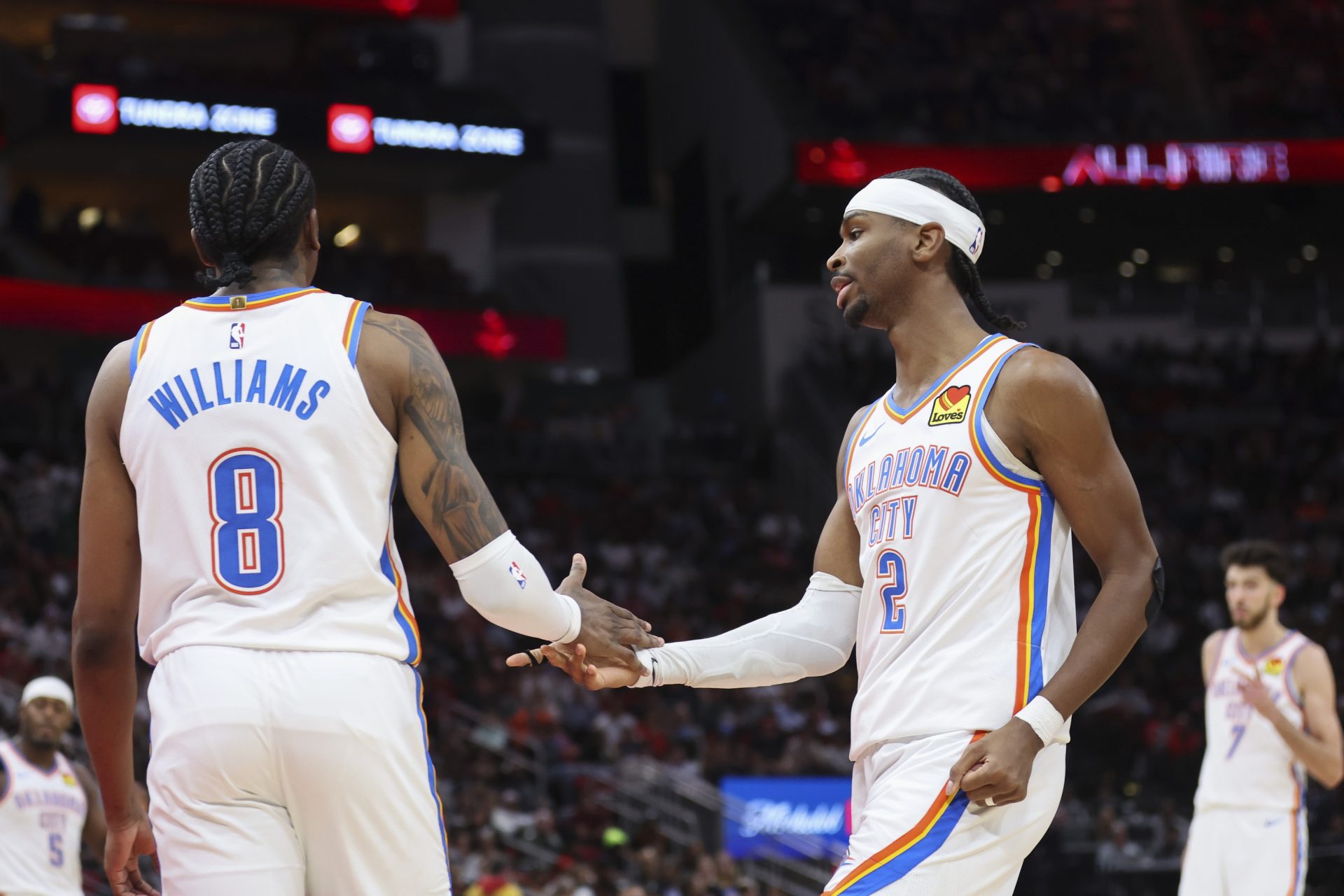 Oklahoma City Thunder guard Jalen Williams (8) and guard Shai Gilgeous-Alexander (2) react after a play during the third quarter against the Houston Rockets at Toyota Center.