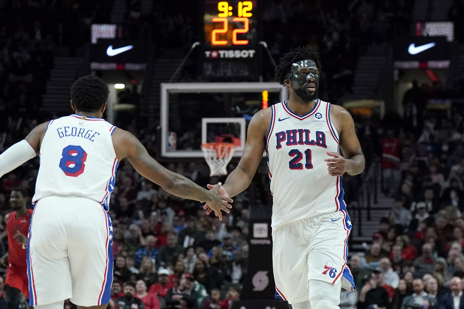Philadelphia 76ers center Joel Embiid (21) and forward Paul George (8) high five during the second half against the Portland Trail Blazers at Moda Center.