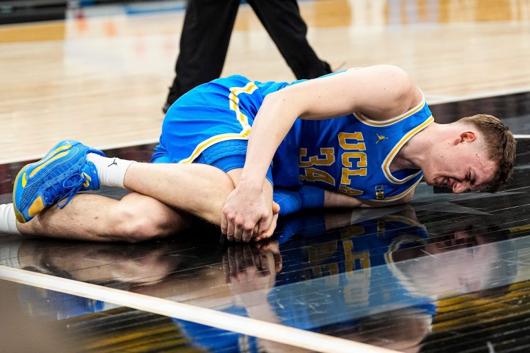 UCLA forward Tyler Bilodeau falls on the court due to injury during the first half of Big Ten tournament quarterfinal against Michigan State - 
Source: Imagn