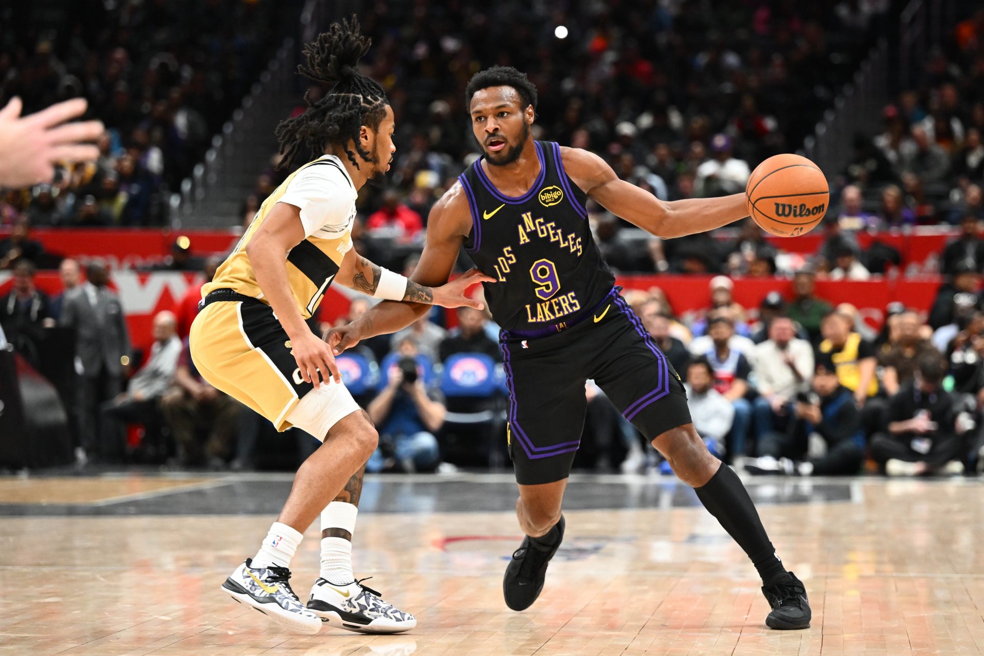 Los Angeles Lakers guard Bronny James (9) dribbles and is defended by Washington Wizards guard Sharife Cooper (13) the second half at Capital One Arena.