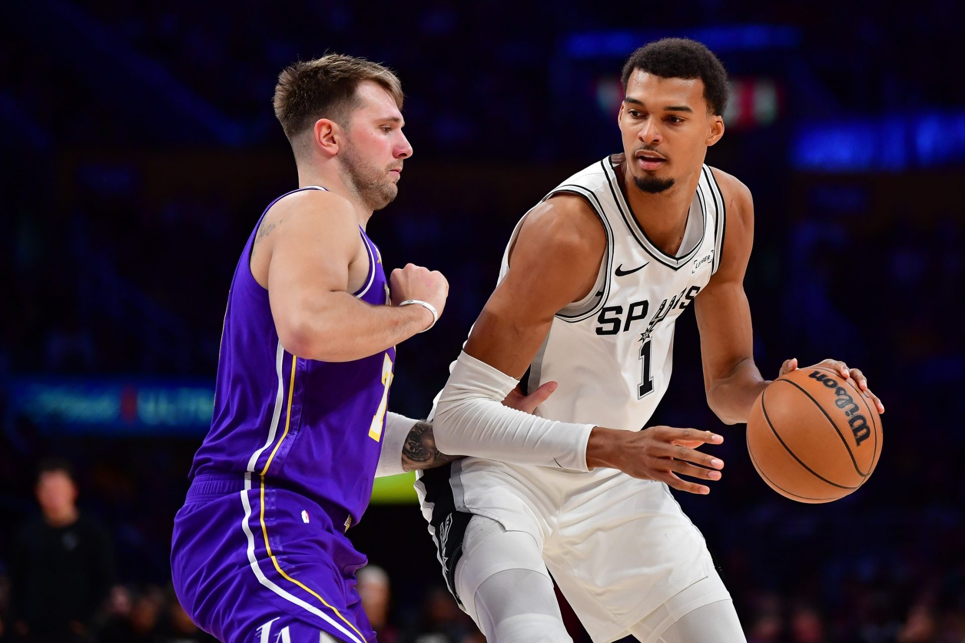 San Antonio Spurs forward Victor Wembanyama (1) moves the ball against Los Angeles Lakers guard Luka Doncic (77) during the second half at Crypto.com Arena - Source: Imagn Images